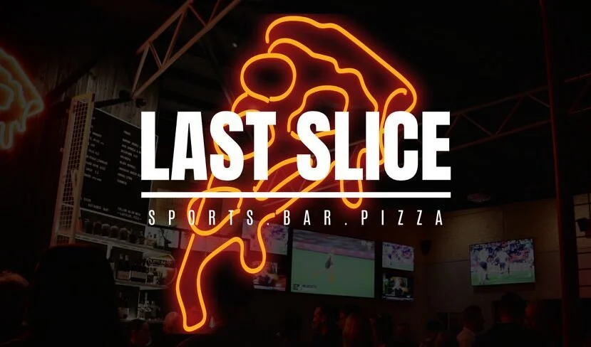 Neon pizza slice sign at Last Slice Sports Bar Pizza
