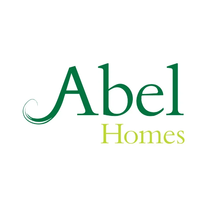 Logo for Abel Homes featuring the word "Abel" in dark green and "Homes" in light green, with a stylized swirl under the letter "A".