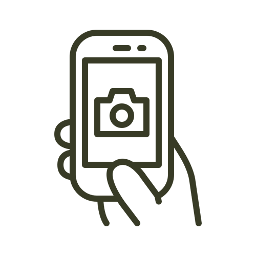 Line drawing of a hand holding a smartphone with a camera icon on the screen.