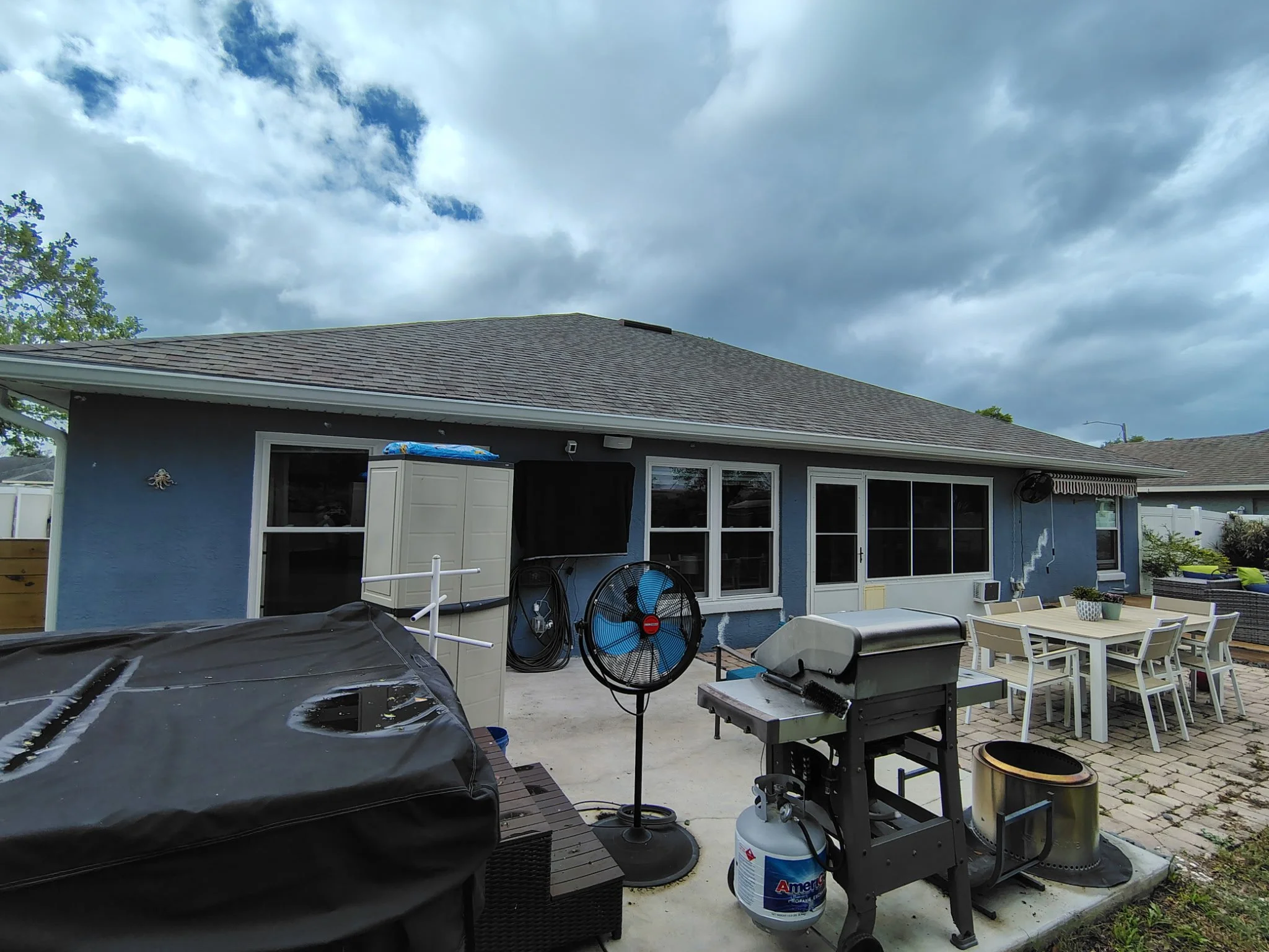 Back patio exterior of Deltona home before painting showing stucco wear and outdoor space