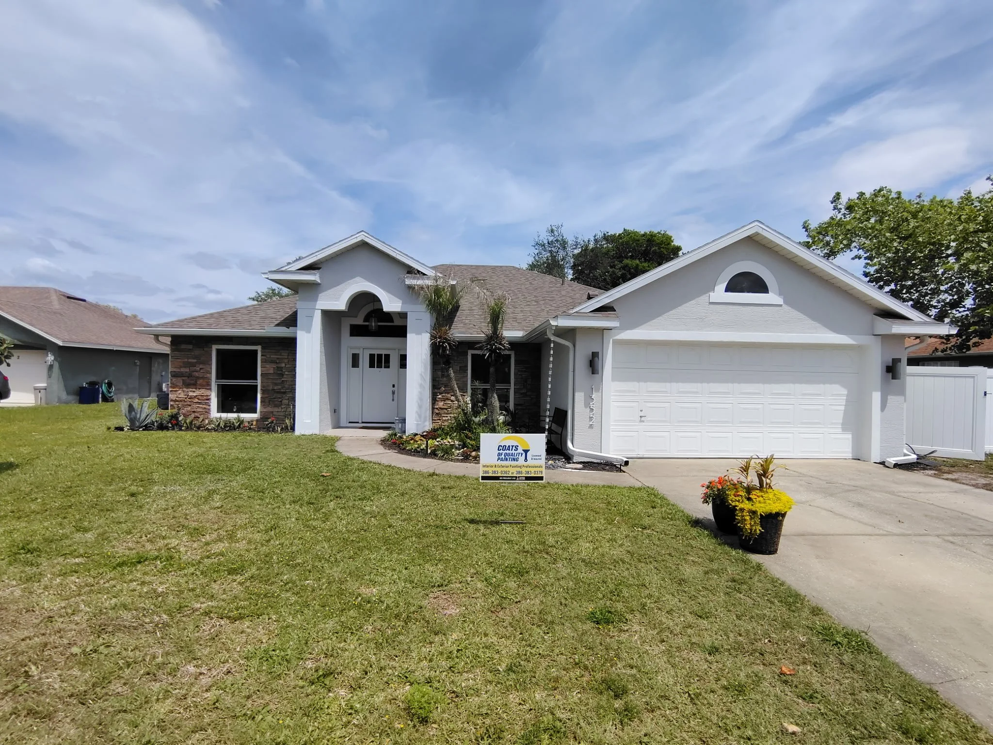 all white exterior house painting Deltona FL modern curb appeal stucco home Coats of Quality Painting