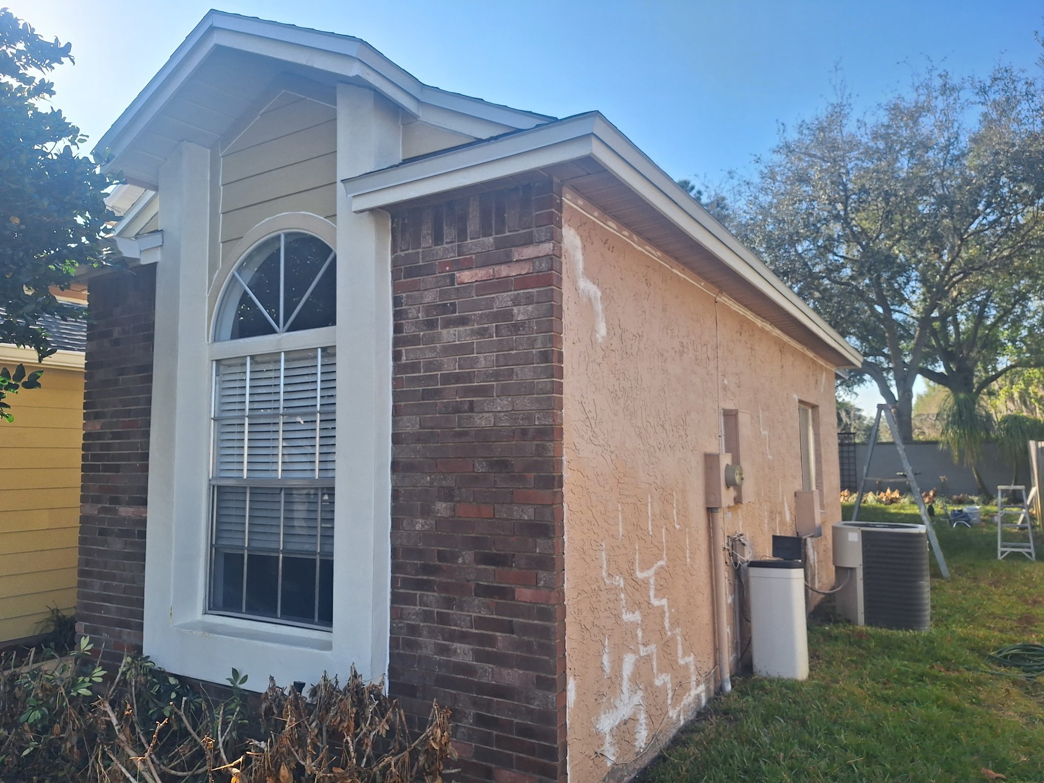 Stucco patch repairs on Oviedo FL home before exterior painting