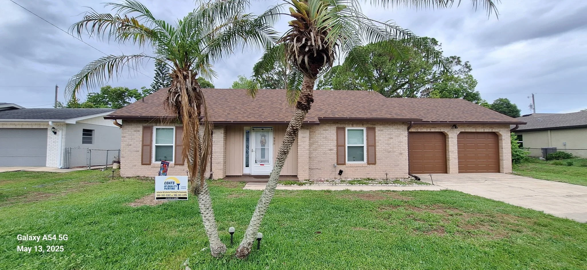 Hardie Board siding painting in Volusia County, Florida — light tan exterior with brown trim completed by Coats of Quality Painting, expert house painters near Daytona Beach, Port Orange, Ormond Beach, New Smyrna Beach, and Deltona
