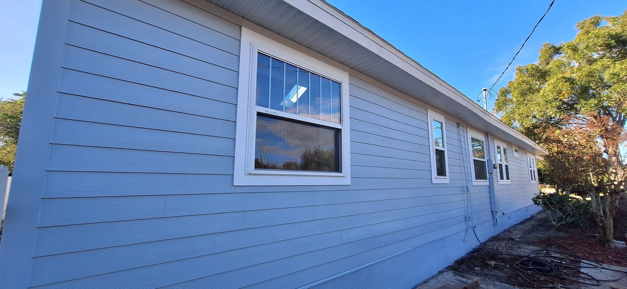 This photo highlights a completed exterior siding painting project in Orlando, FL. Our Orlando exterior painters focus on proper surface preparation, premium materials, and expert application to ensure durability and curb appeal. Coats of Quality Pai