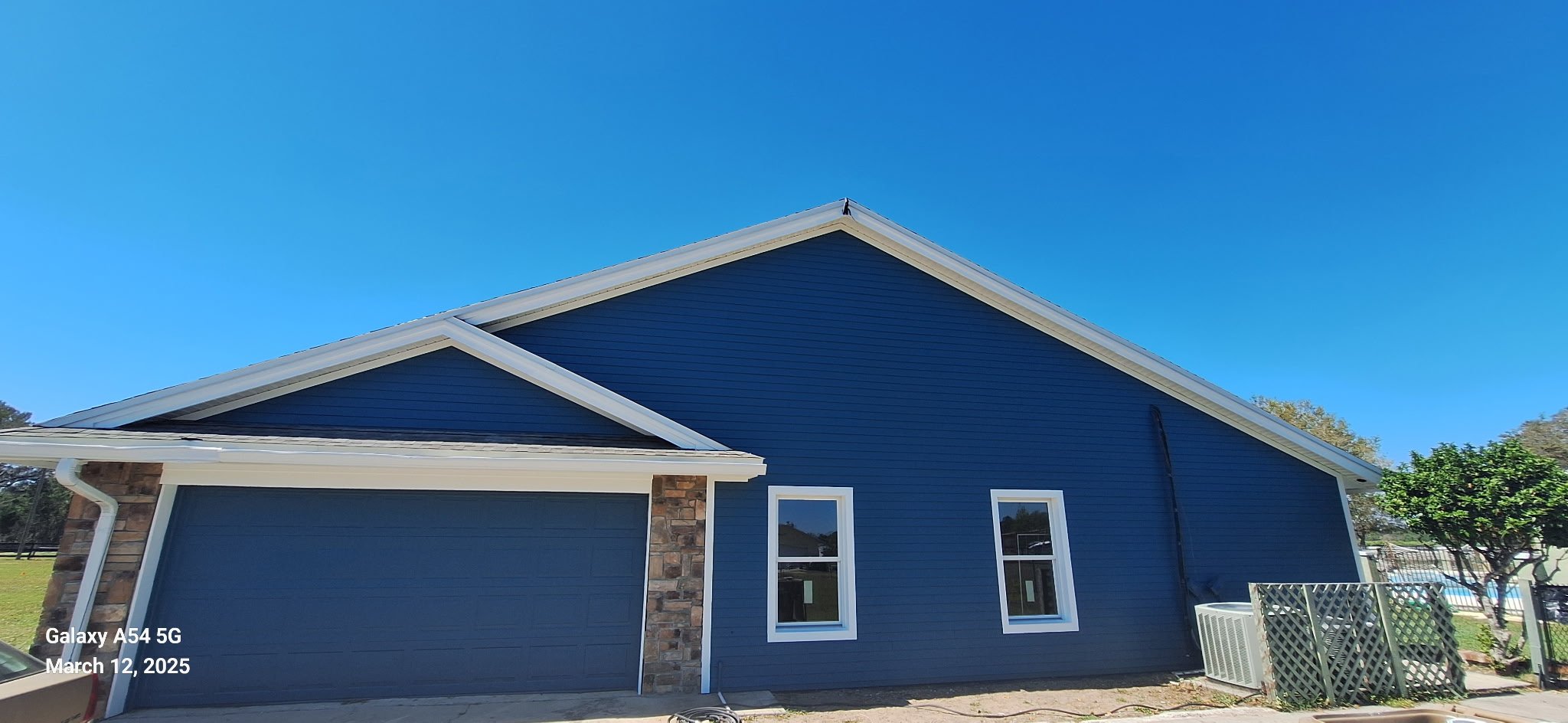 Garage exterior painted deep blue with white trim on Ocala Florida home