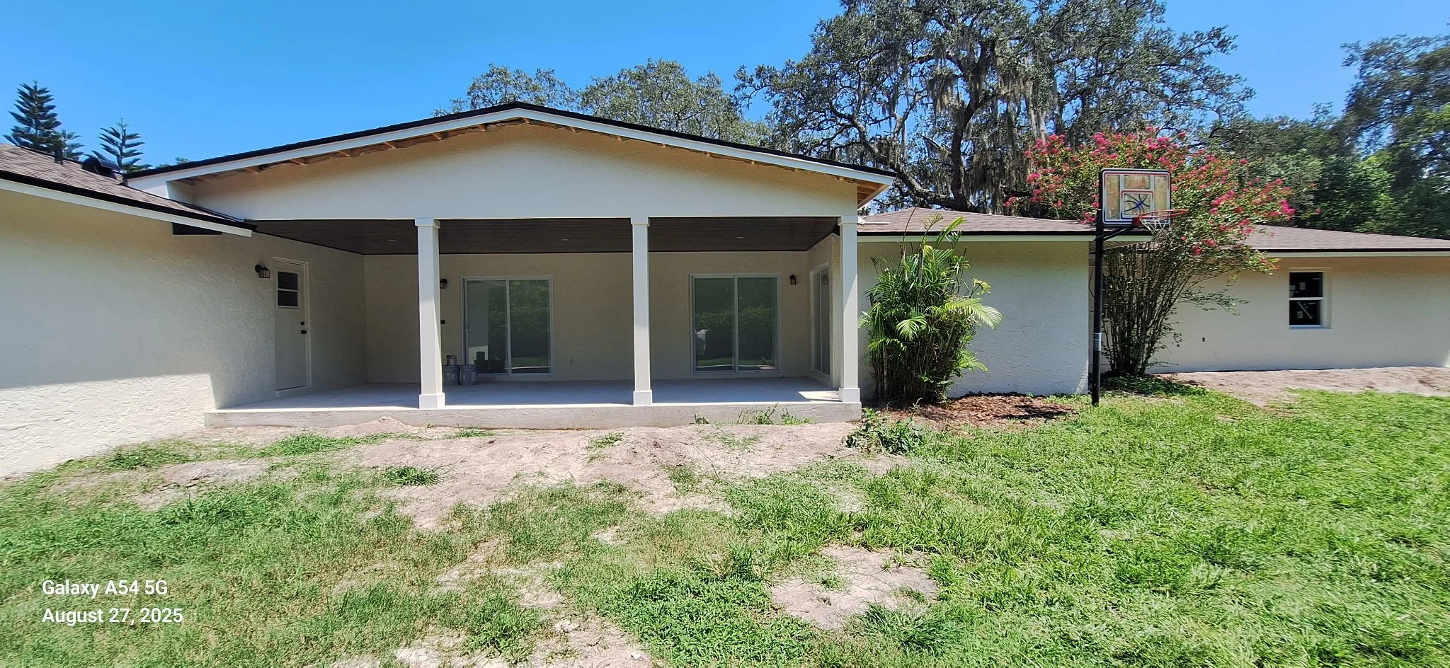 Exterior house painting project in Winter Springs FL featuring freshly painted stucco walls and covered patio in Seminole County