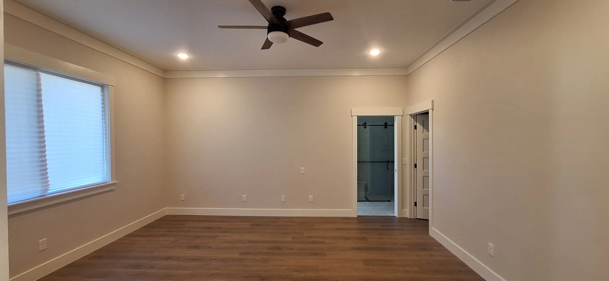 Soft, warm interior painting in the primary bedroom of this Sanford, FL new build.