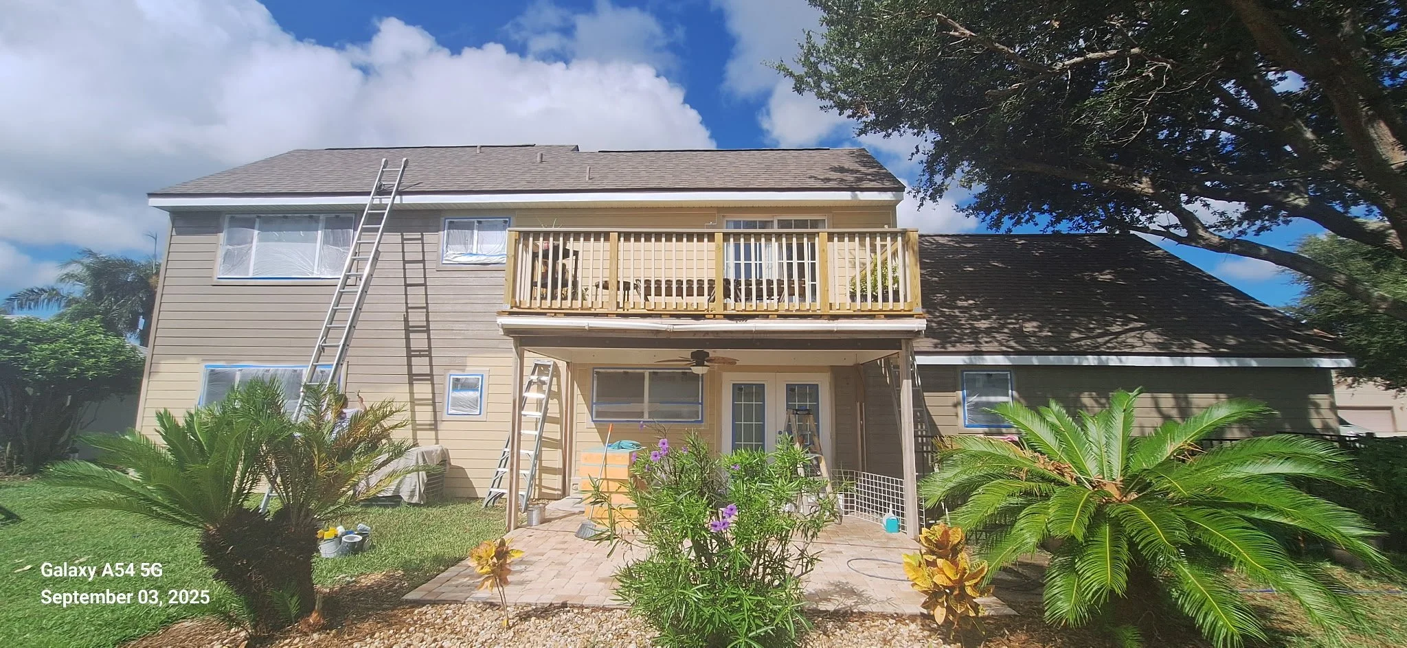 Before: Faded yellow Hardie Board siding in need of a fresh, durable exterior finish for this Melbourne, FL home.