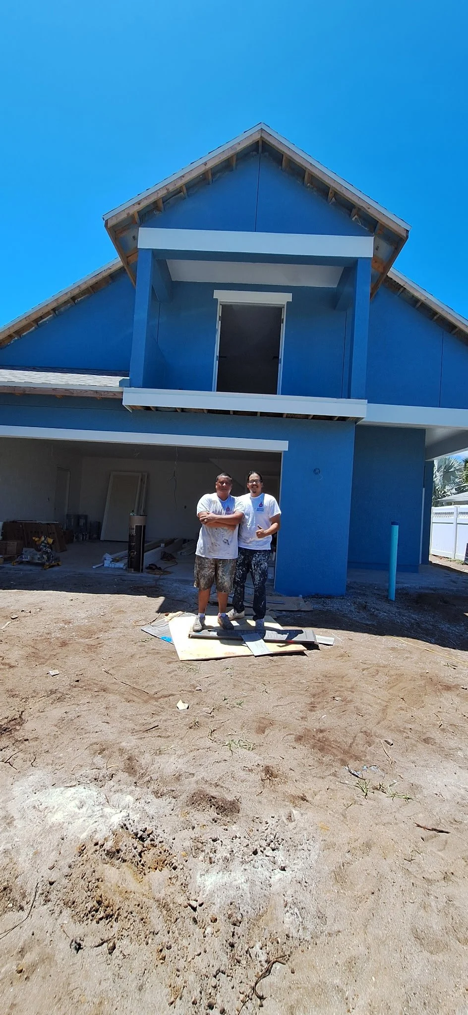 Upper gable detail of blue coastal home with white trim New Smyrna Beach Florida