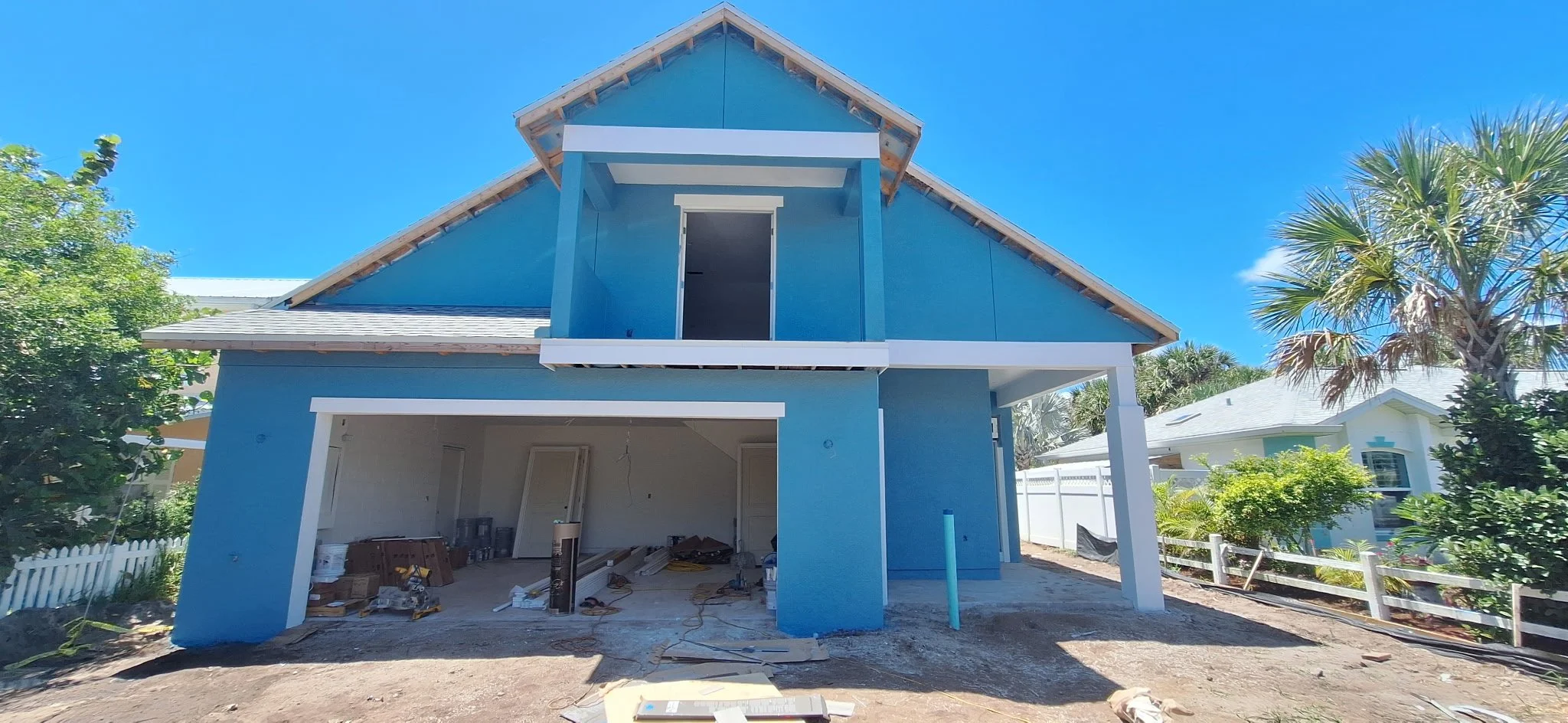 Finished blue coastal home exterior with white trim New Smyrna Beach Florida