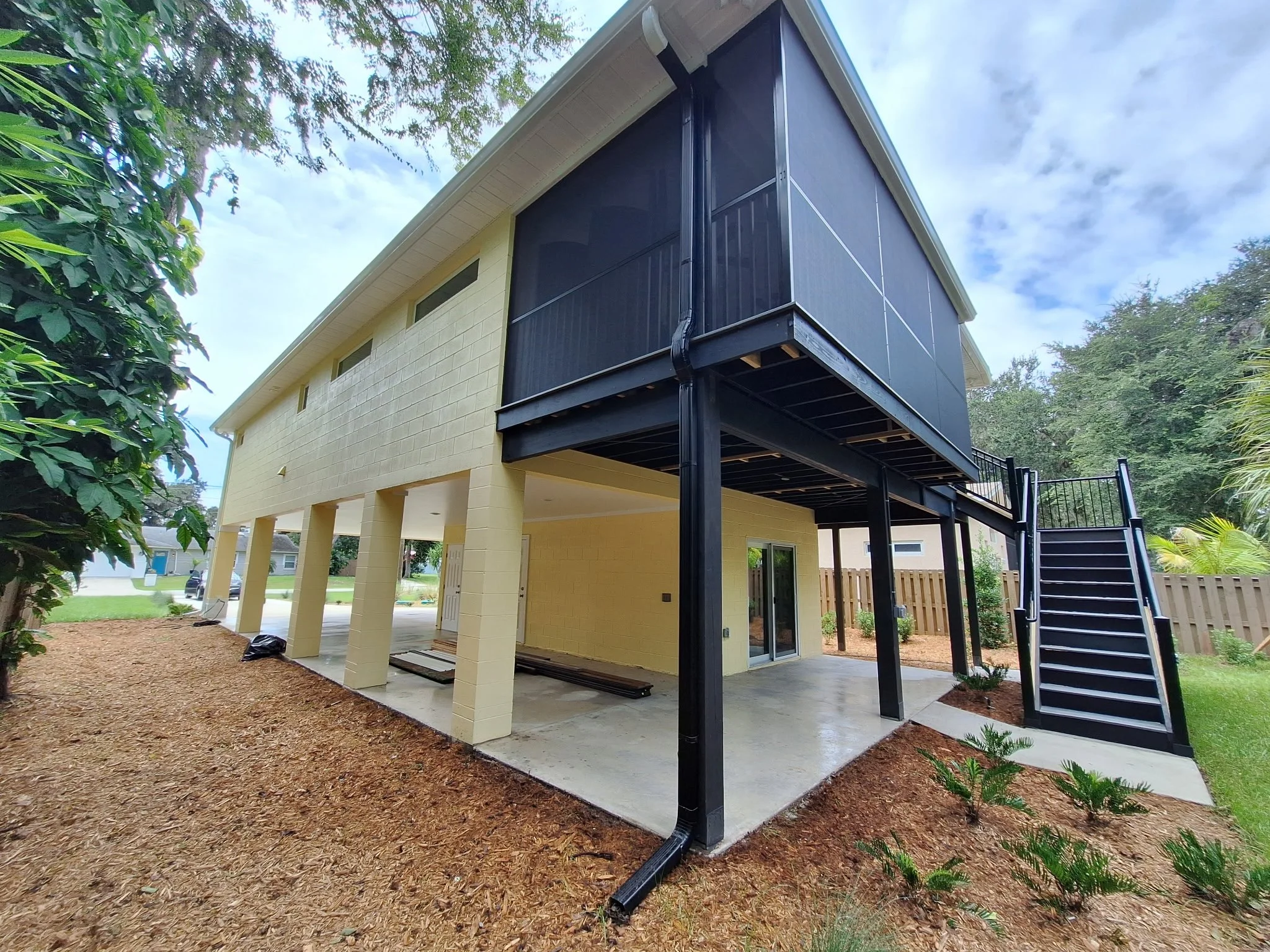 Black painted staircase and railings on New Smyrna Beach canal home exterior