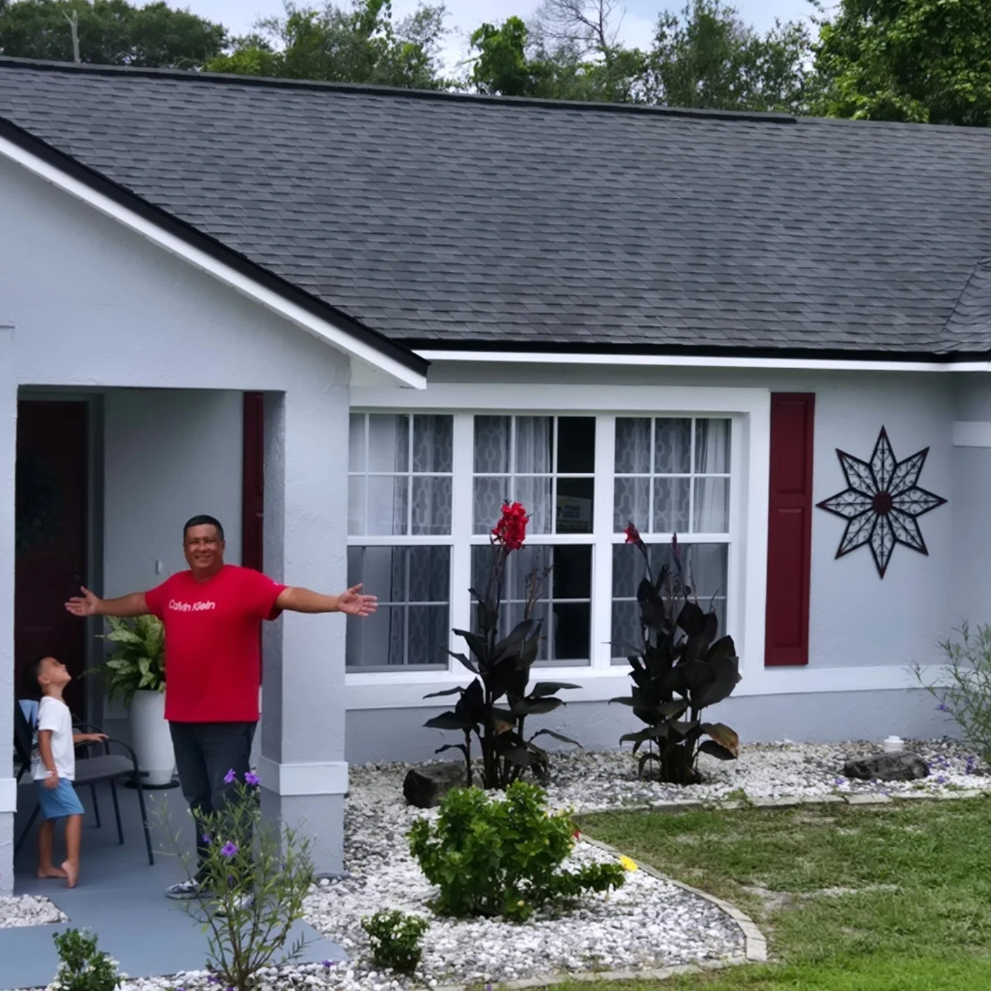 Exterior house painting in Deltona FL by Coats of Quality Painting, featuring fresh gray siding, white trim, and a welcoming front porch.