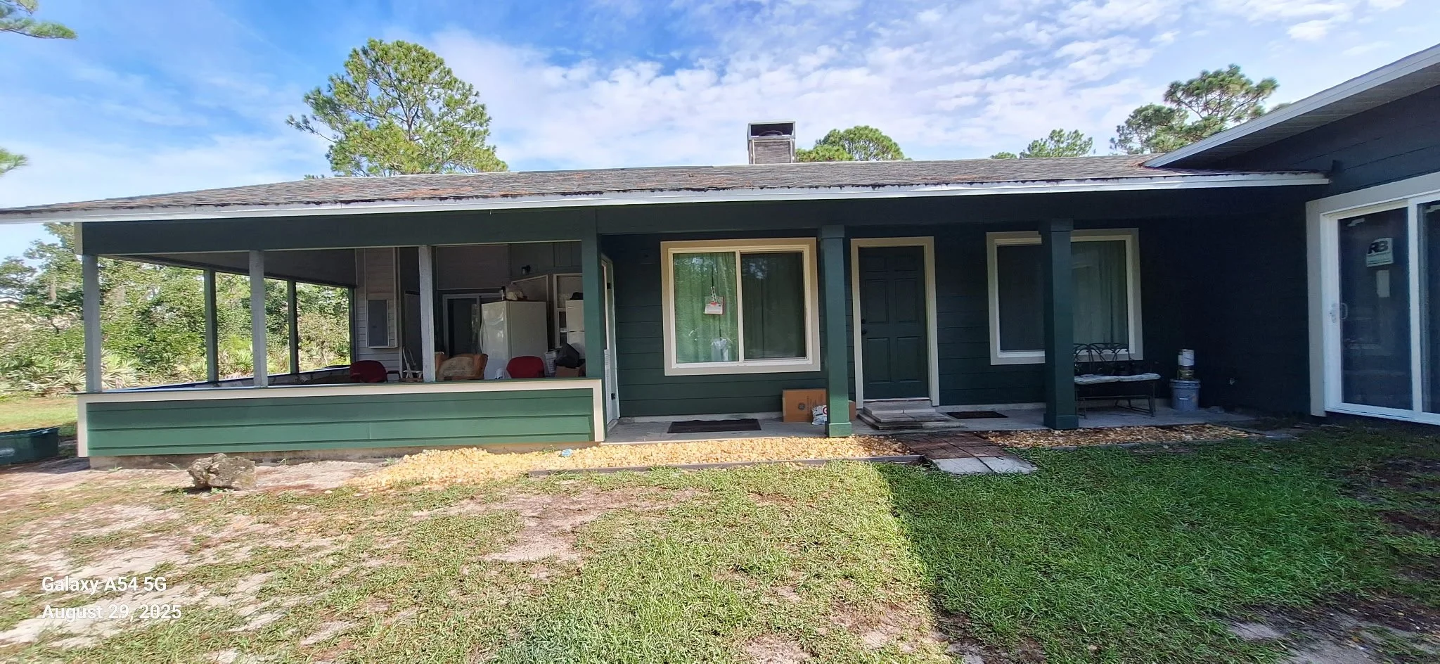 Professional exterior house painting in New Smyrna Beach, FL featuring durable Hardie board paint designed for coastal weather, humidity, and sun exposure. See this fresh green exterior transformation.