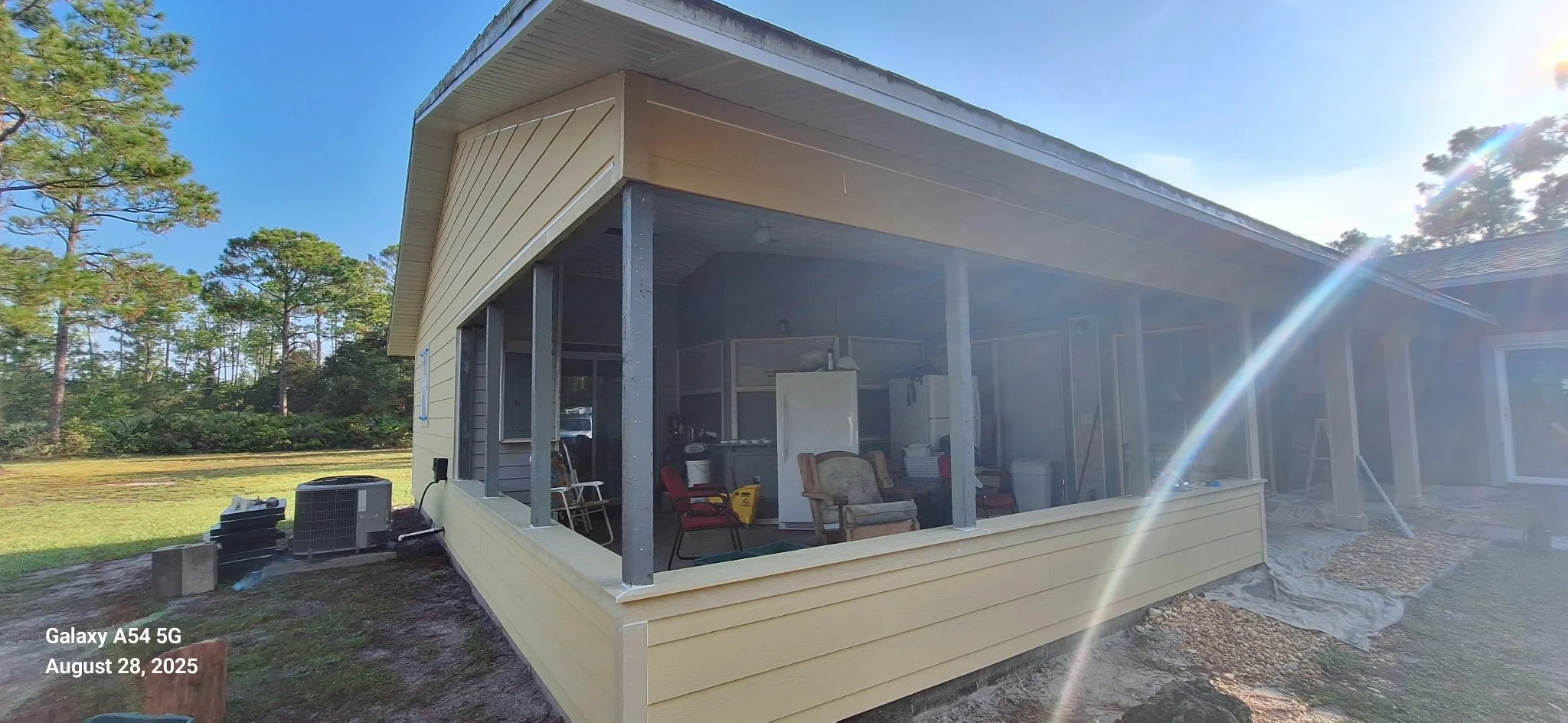 This image captures the porch and trim preparation phase of an exterior house painting project in New Smyrna Beach. Detailed masking and prep work help protect surfaces and ensure crisp lines for a long-lasting, professional finish.