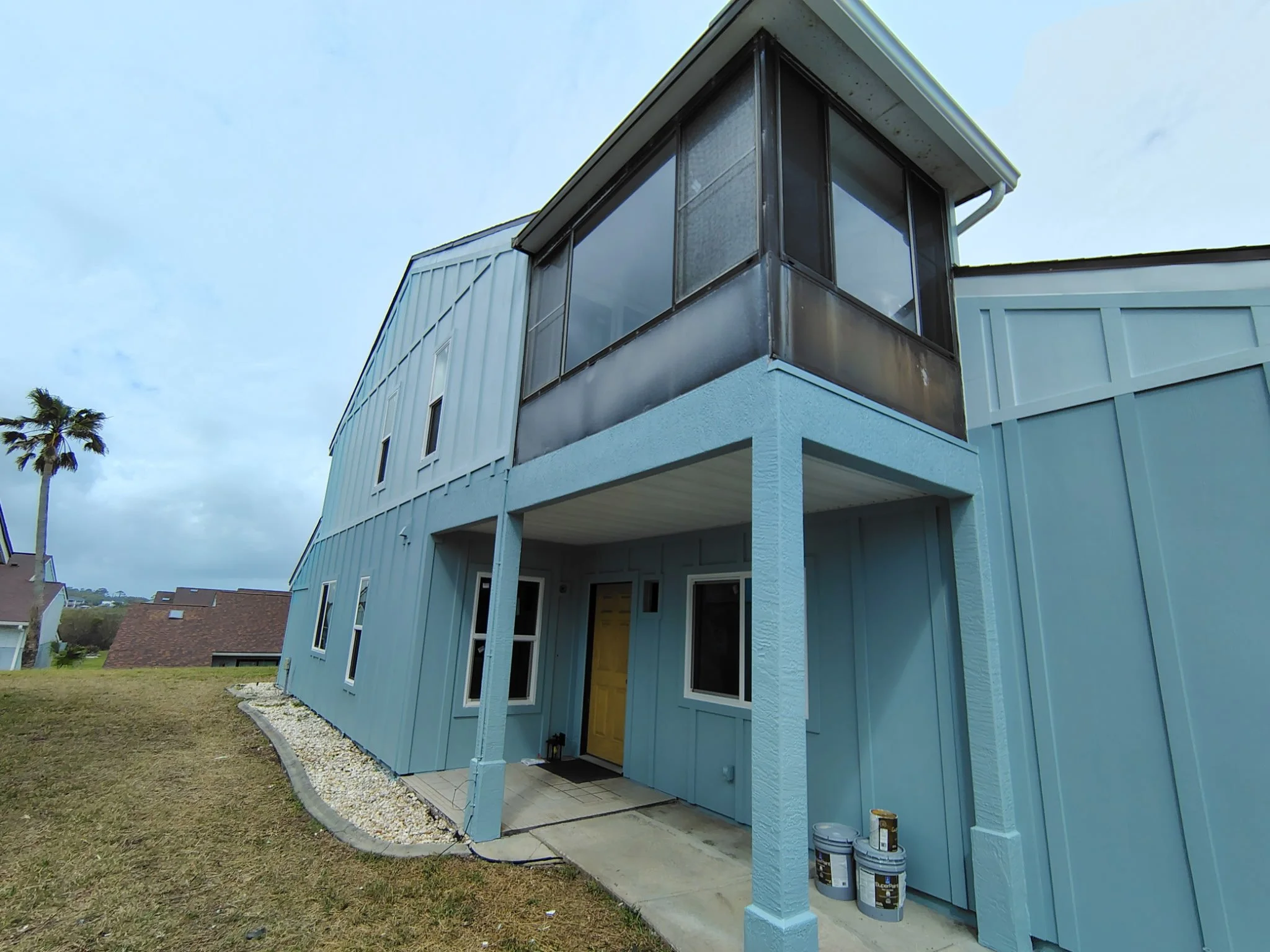 Flagler Beach home exterior painting elevated coastal design Hardie siding transformation