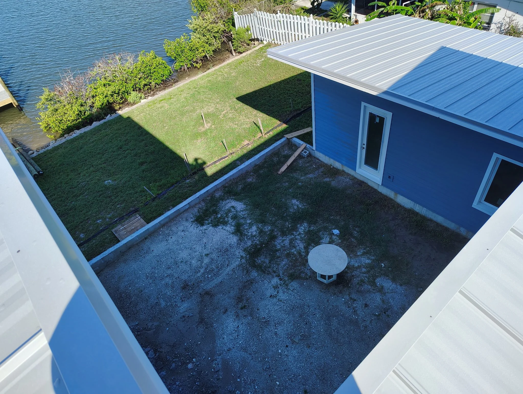 Port Orange Coastal Blue Exterior Paint Metal Roof Courtyard View