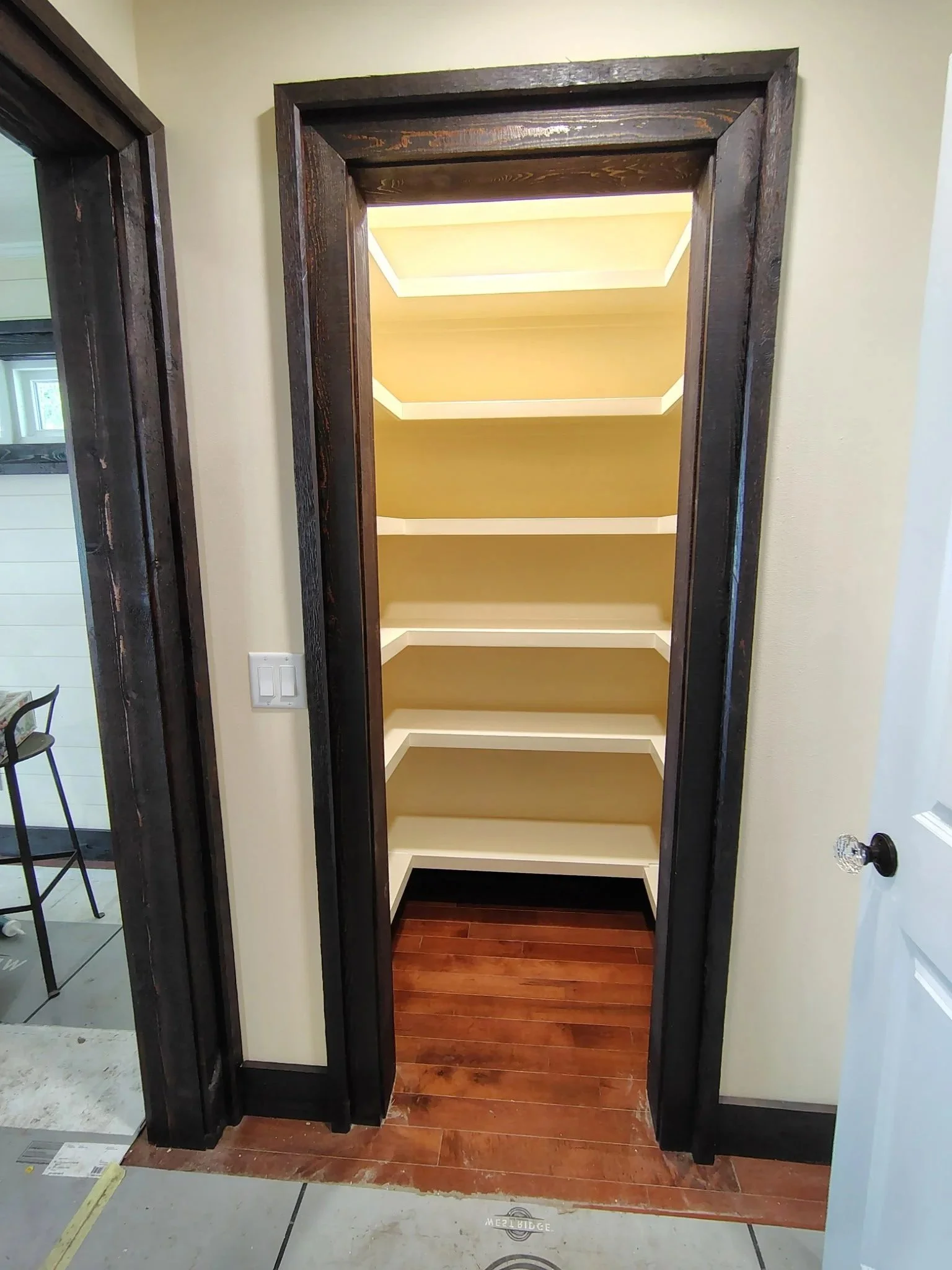 Completed Pantry Shelving with Dark Stained Door Trim