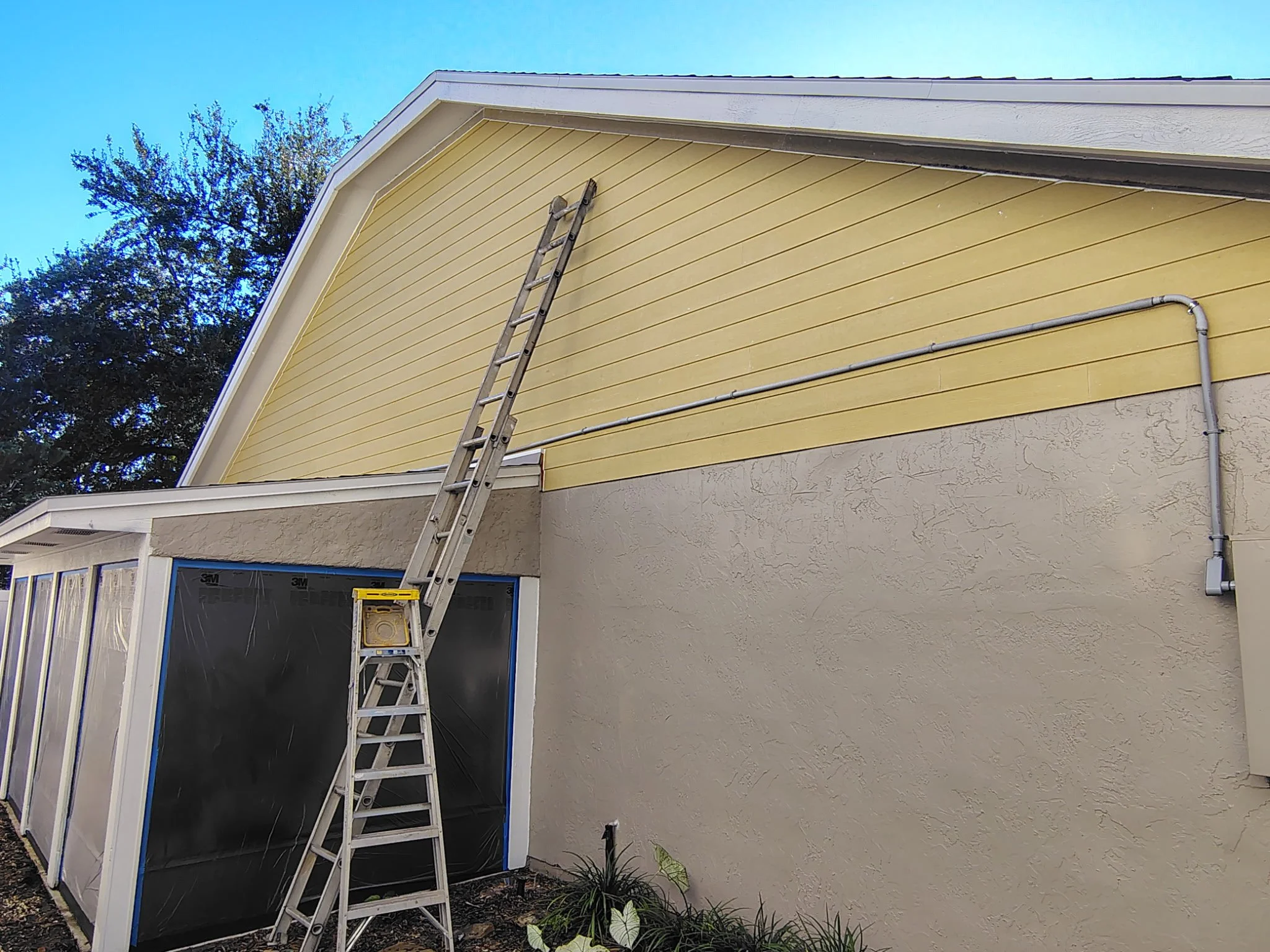 Large upper gable and textured stucco