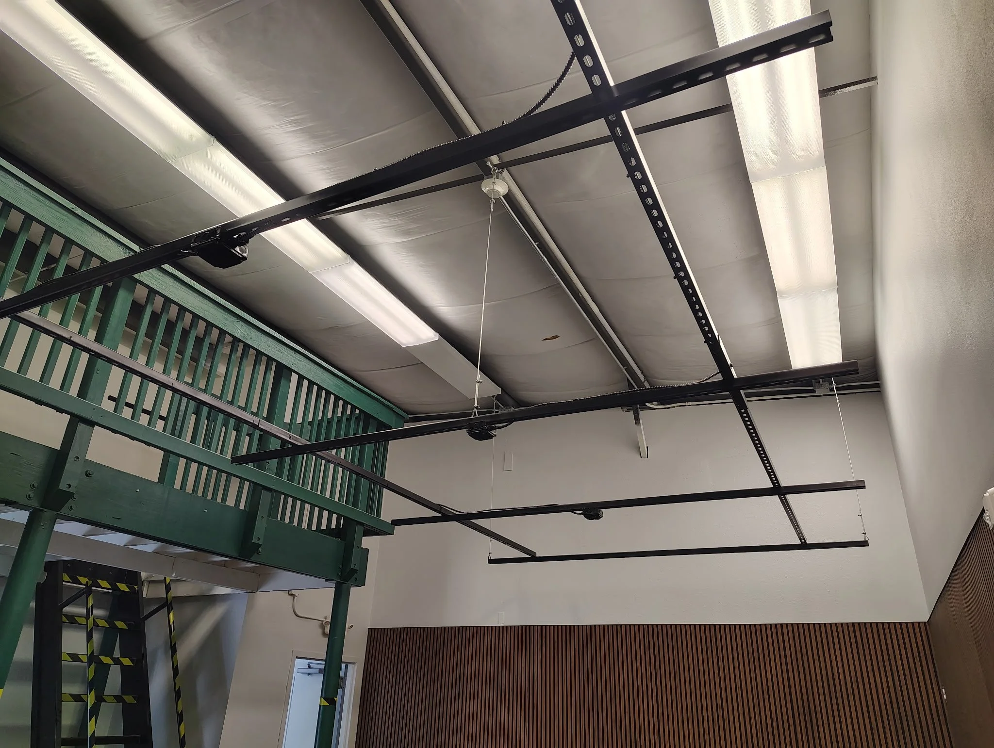 Volusia County business interior painting project with protected flooring, taped wood wall, and commercial painting preparation.