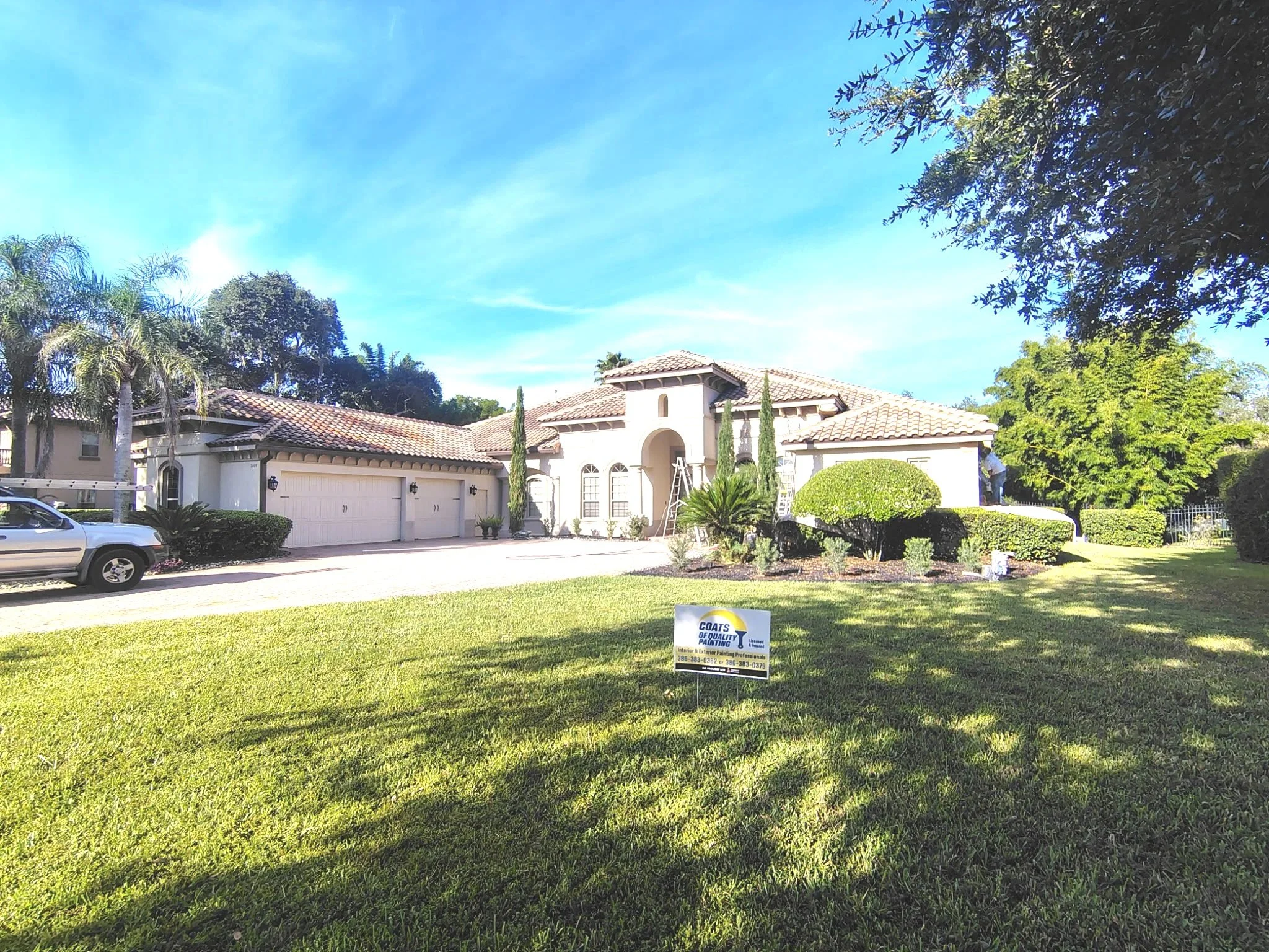 Wide before view of large Sanford Florida home exterior painting project