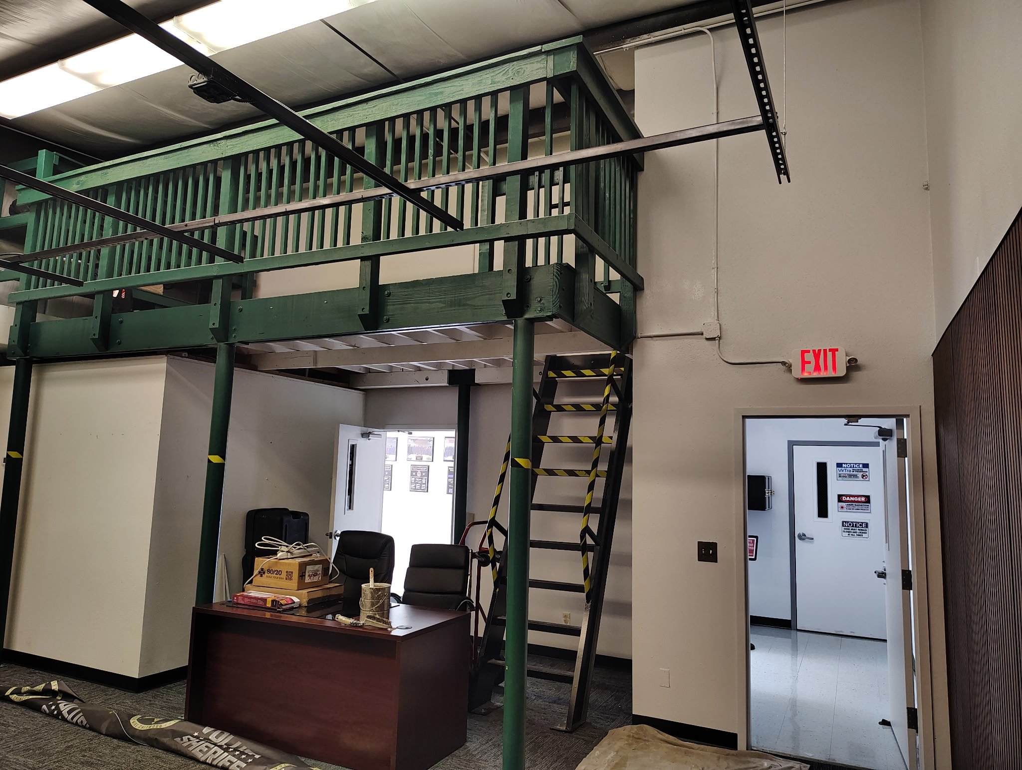 Volusia County commercial interior painting project showing podcast room prep, covered work areas, tall walls, and protected interior surfaces.