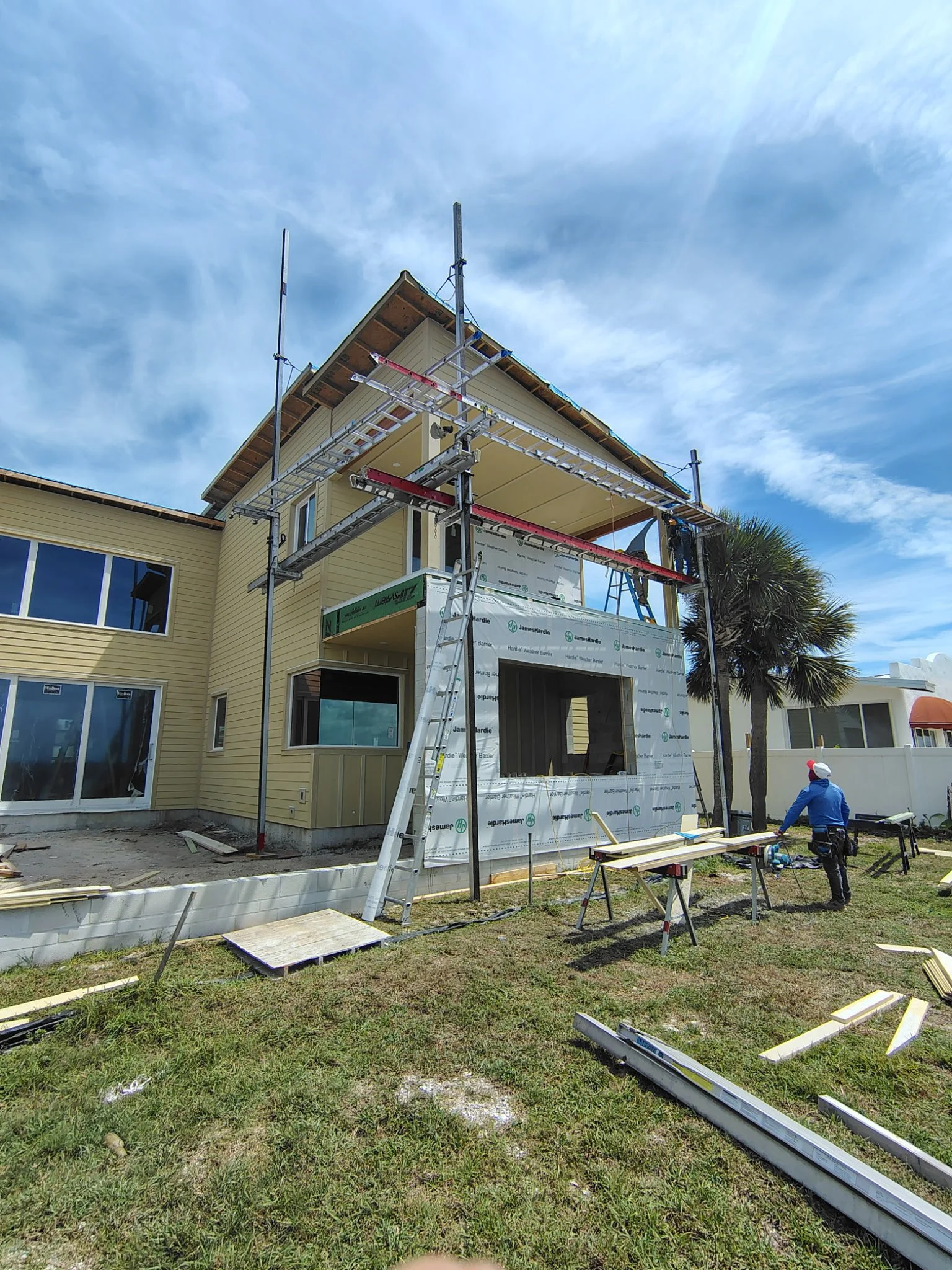 Exterior painting prep with scaffolding on South Daytona home using Hardie board siding and weather barrier