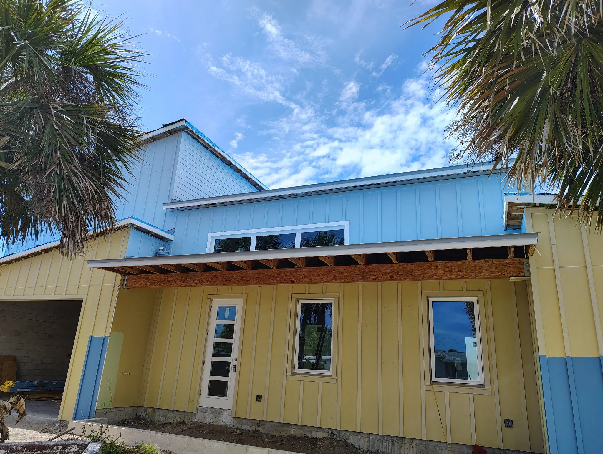 Front view of South Daytona home during exterior painting with modern color blocking and coastal style design