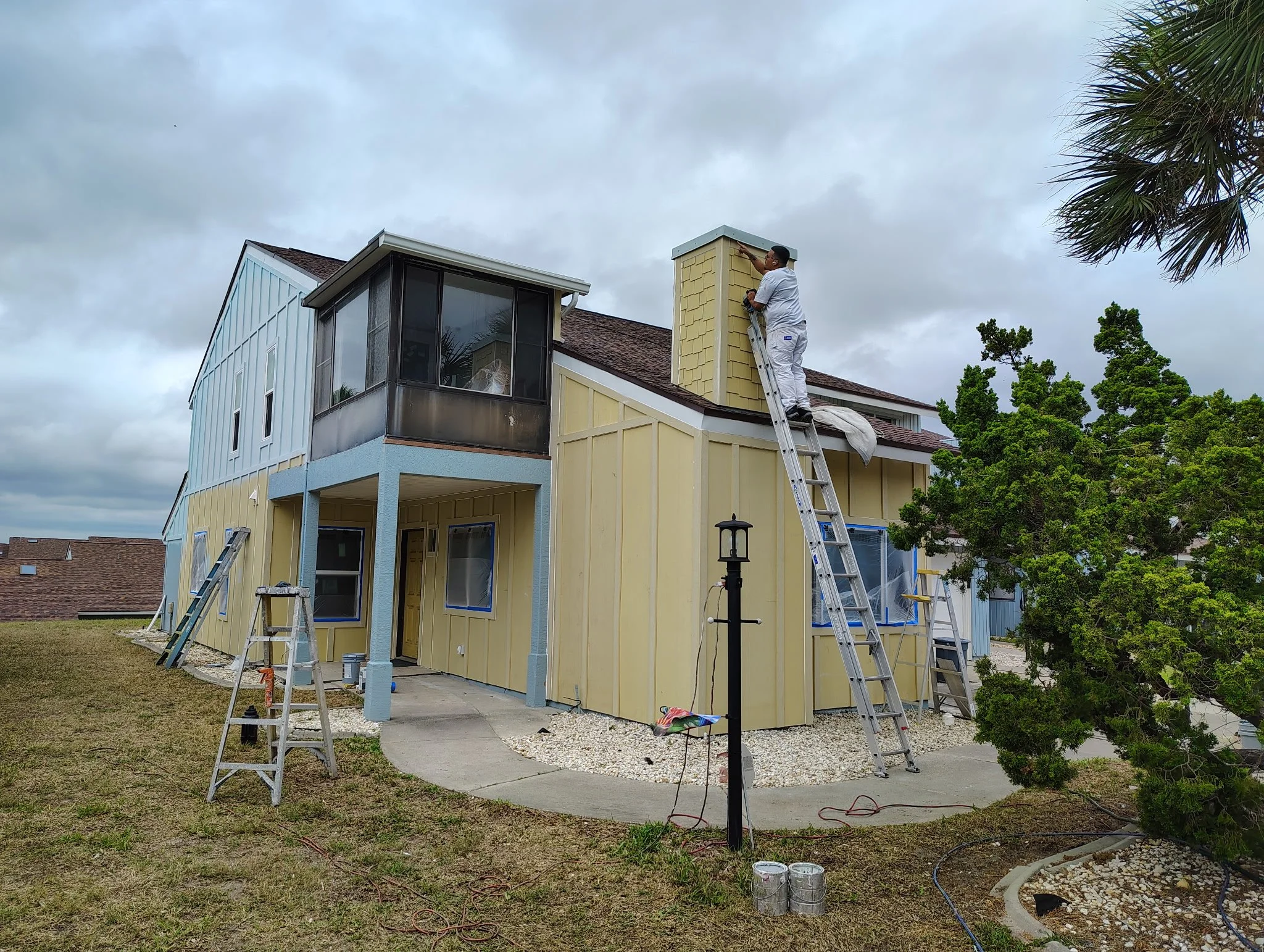 Full exterior painting project in progress with chimney detail in South Daytona Florida