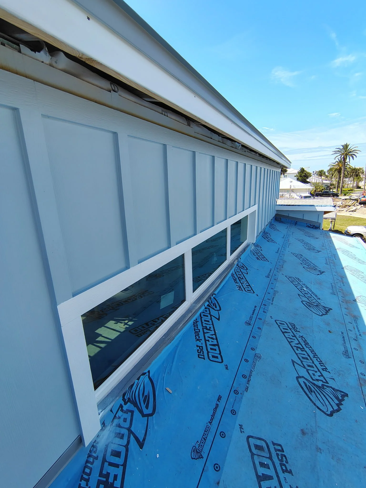 Exterior wall and window detail during painting prep in South Daytona with clean siding and sealed surfaces