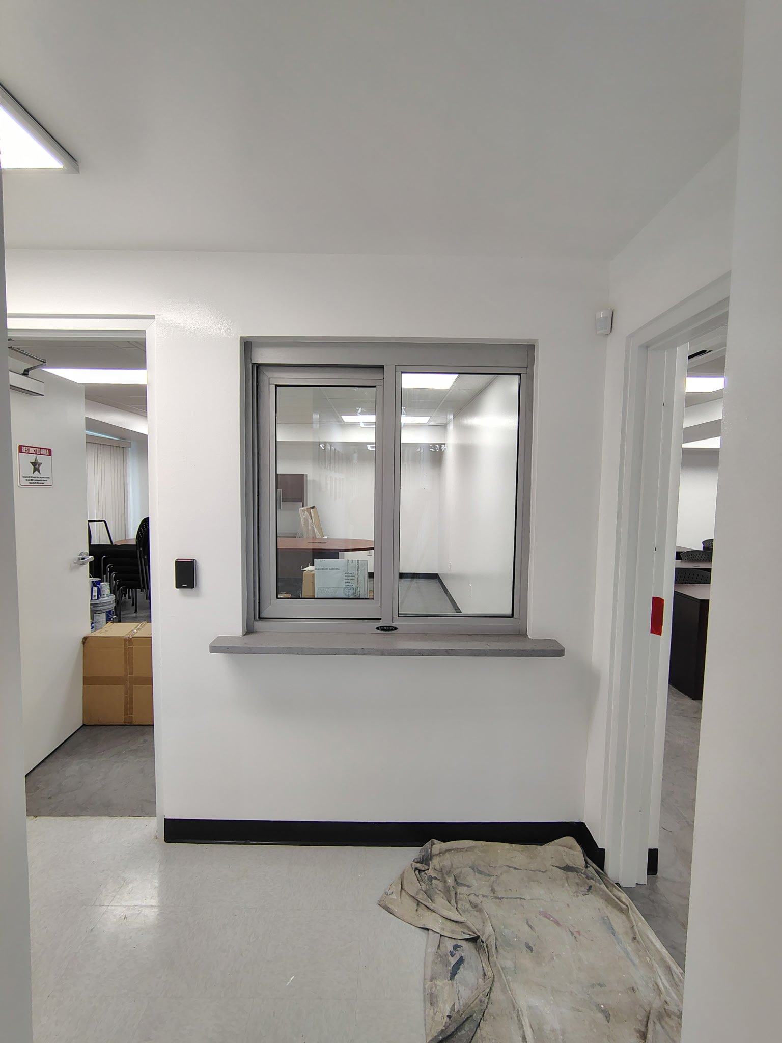 Interior painting around service window at Volusia County Sheriff training facility in Daytona Beach