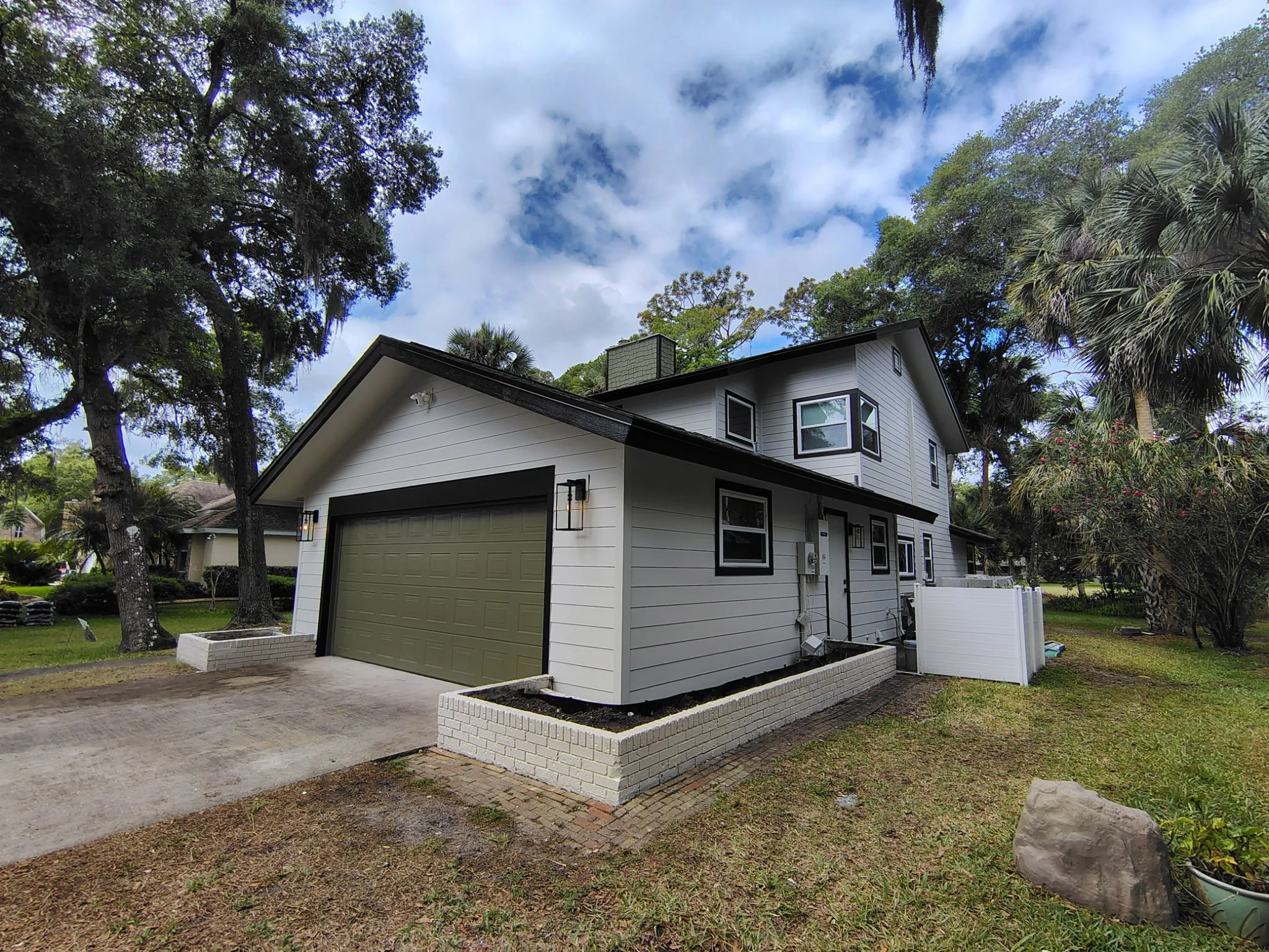 Garage color ties the home into the natural landscape