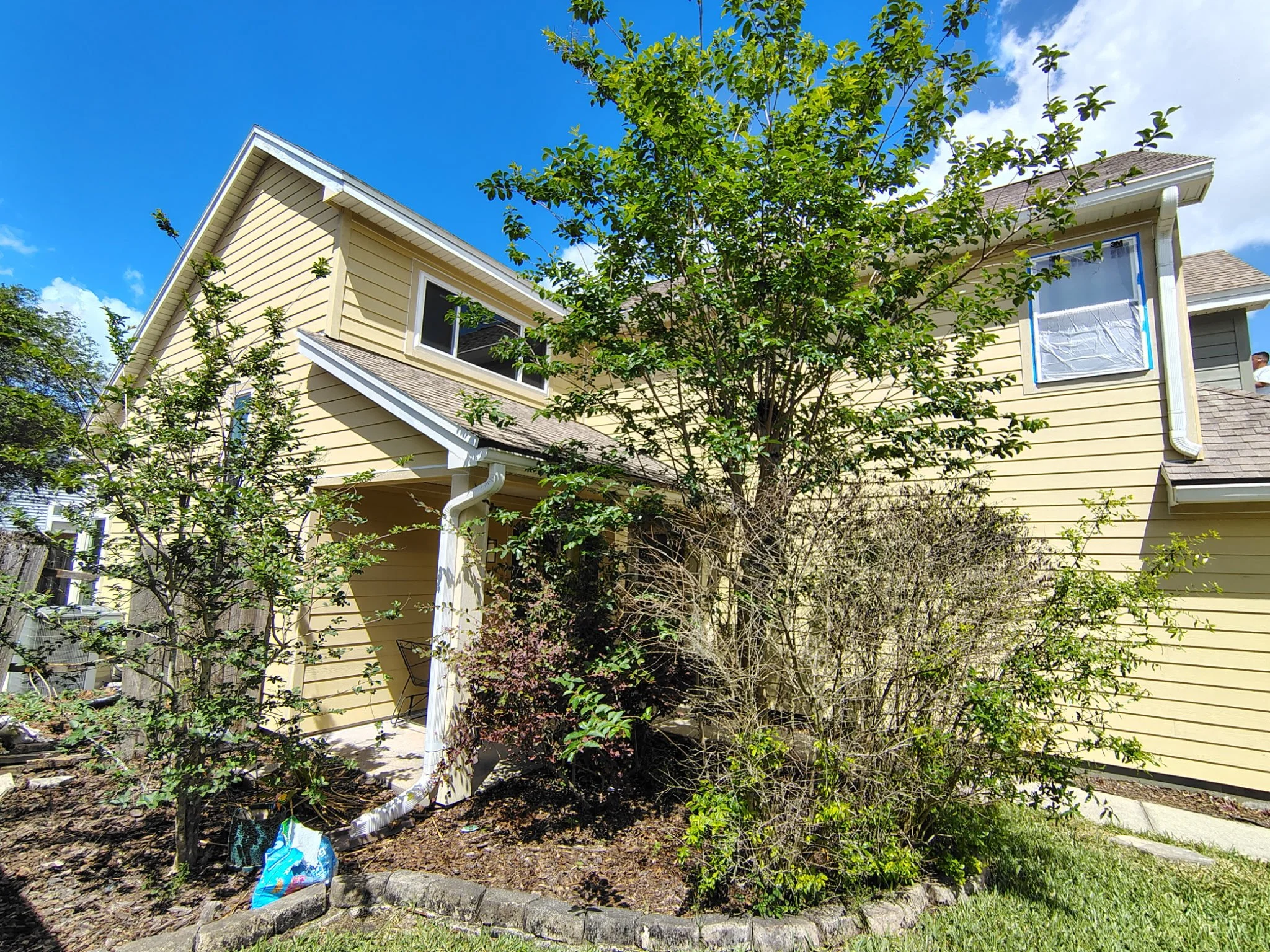 Front entry of Longwood FL home before exterior painting showing trim and siding condition