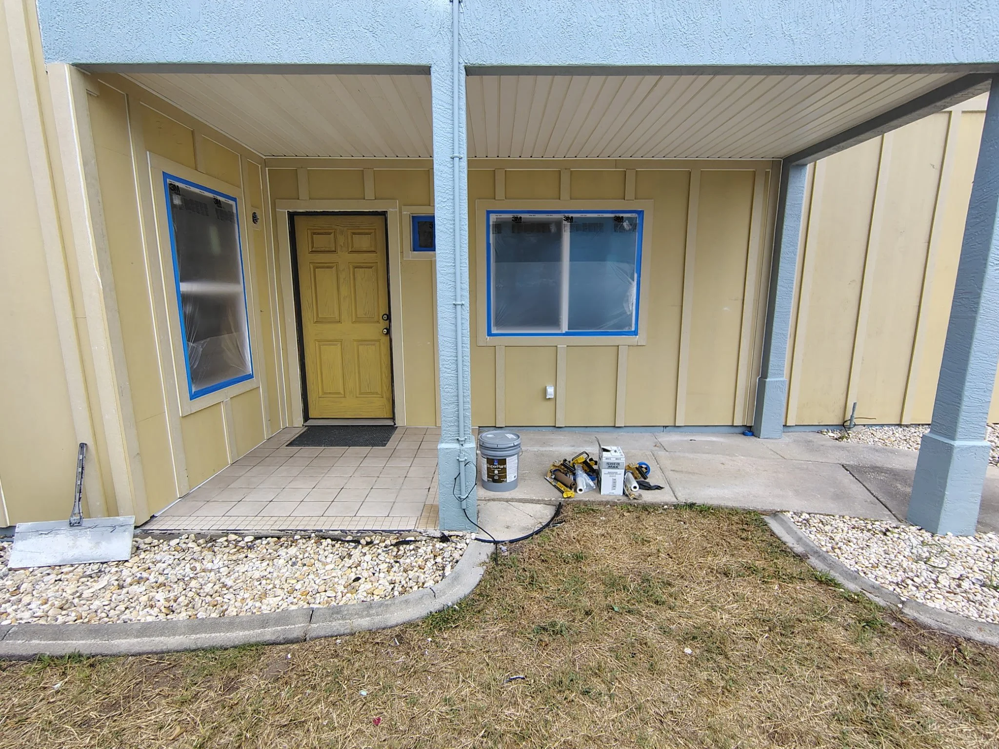 Front entry of home masked and prepped for exterior painting in South Daytona Florida