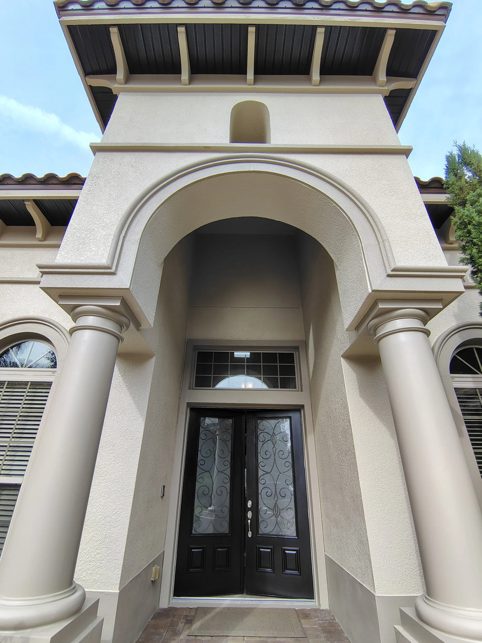 Freshly painted arched entry and columns on Sanford FL stucco home