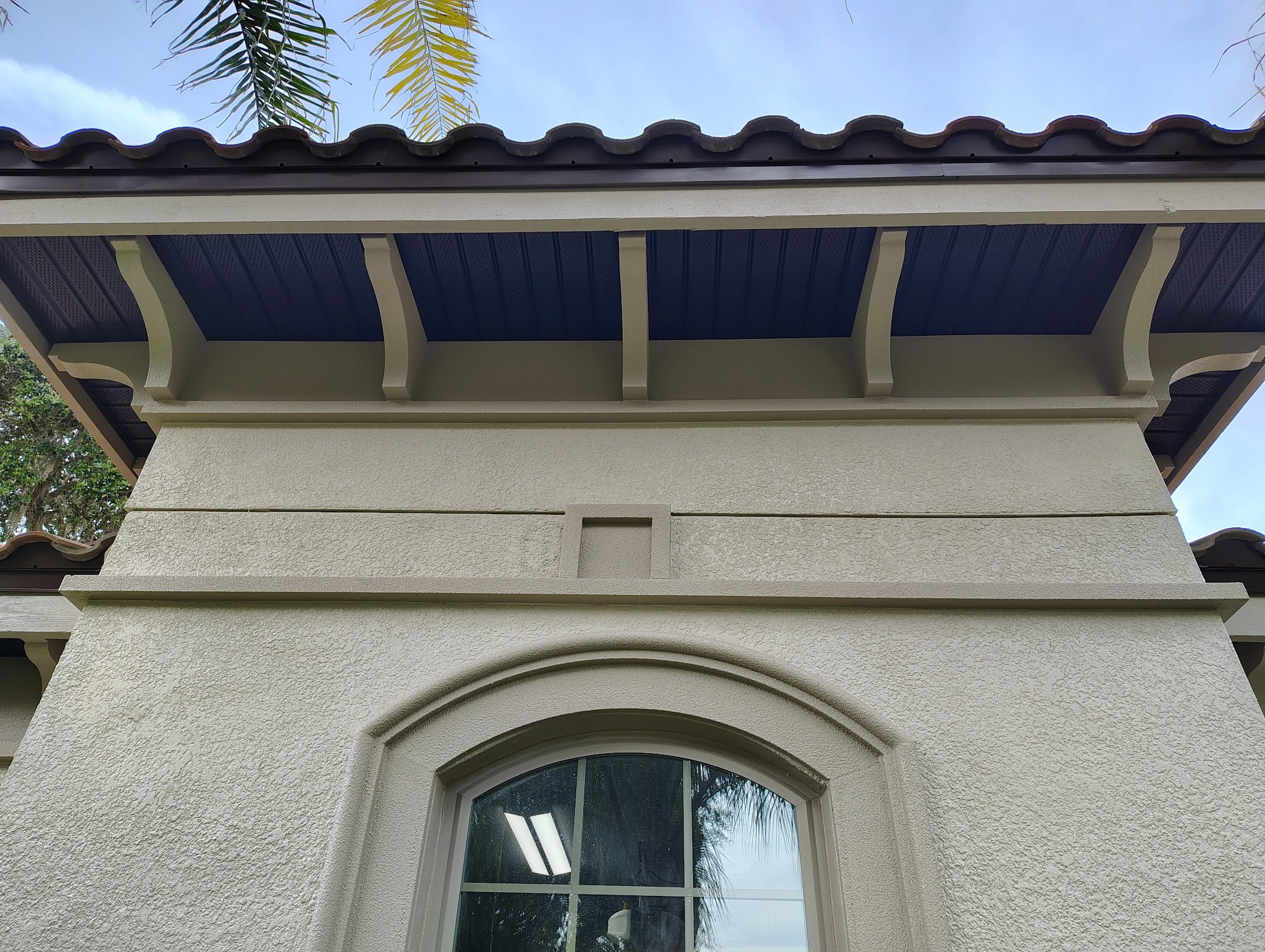 Finished dark soffit and fascia with architectural brackets on Sanford FL home