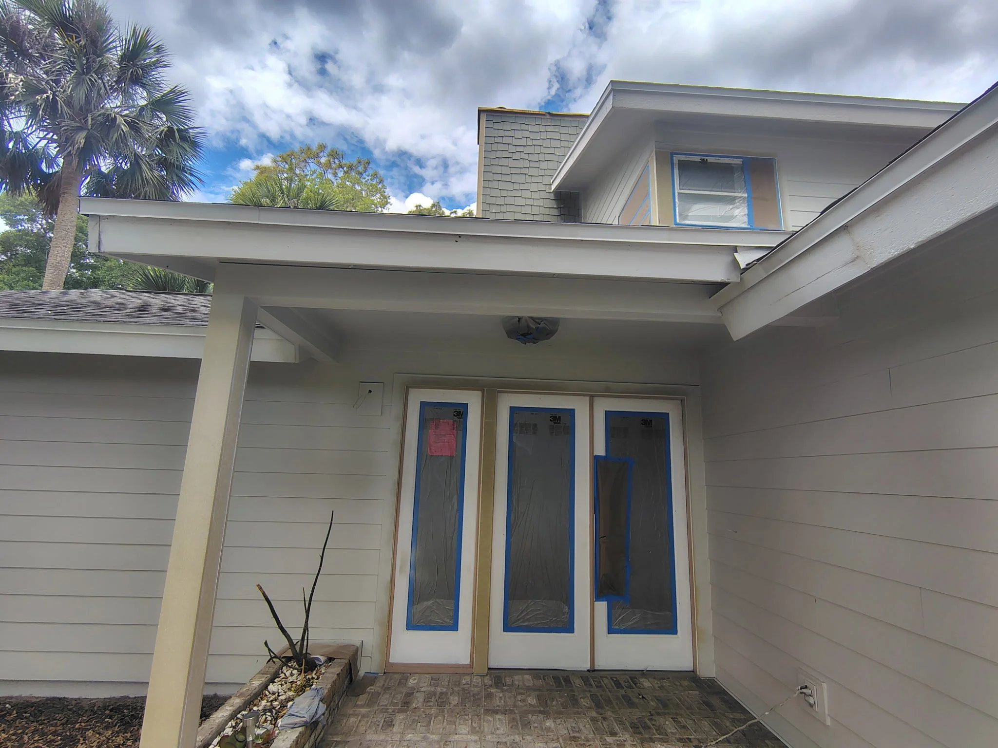 Port Orange exterior painting project focusing on front entryway with doors protected and trim areas prepared for clean finishing