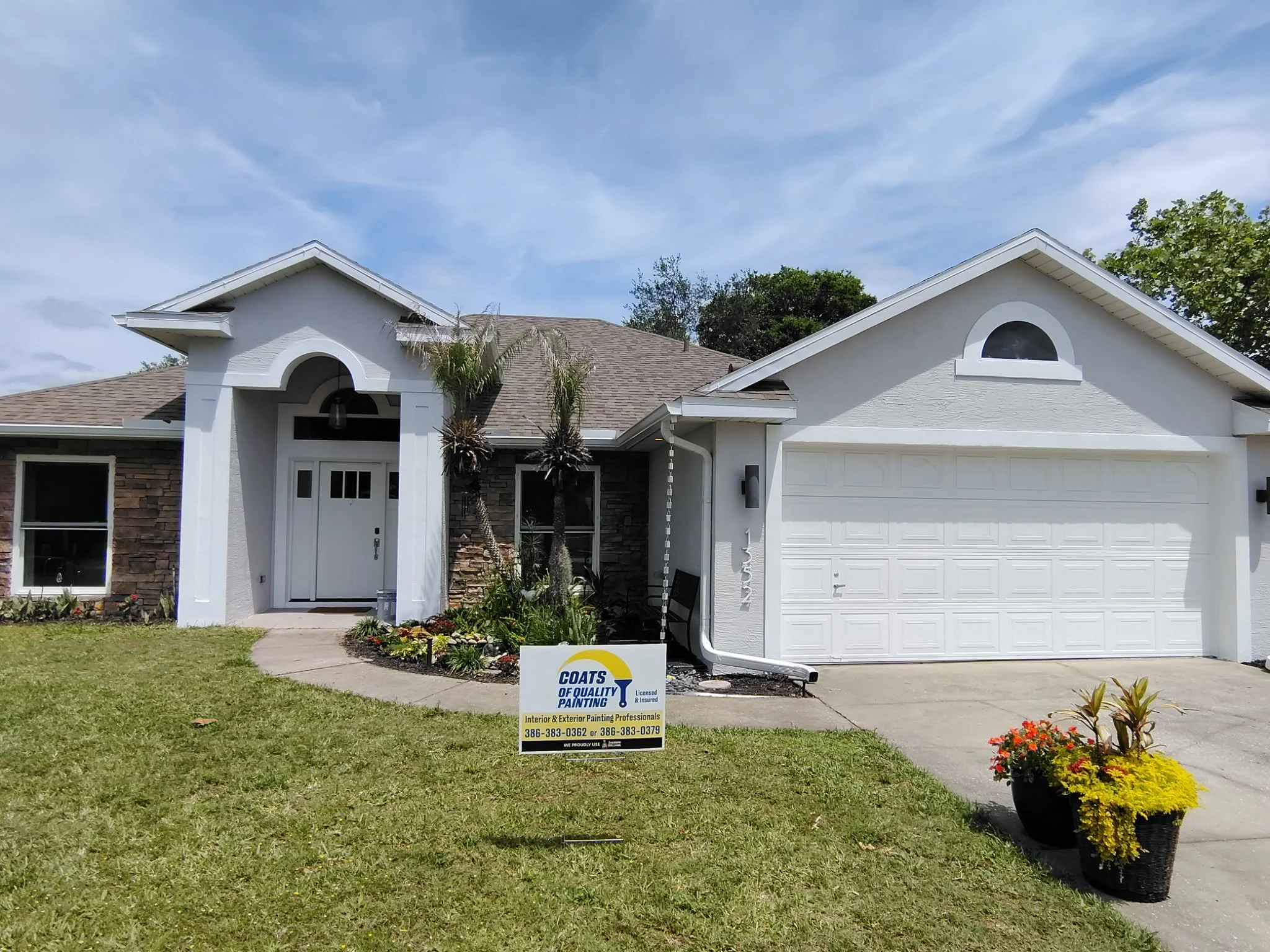 full exterior house after painting white garage entry Deltona Florida