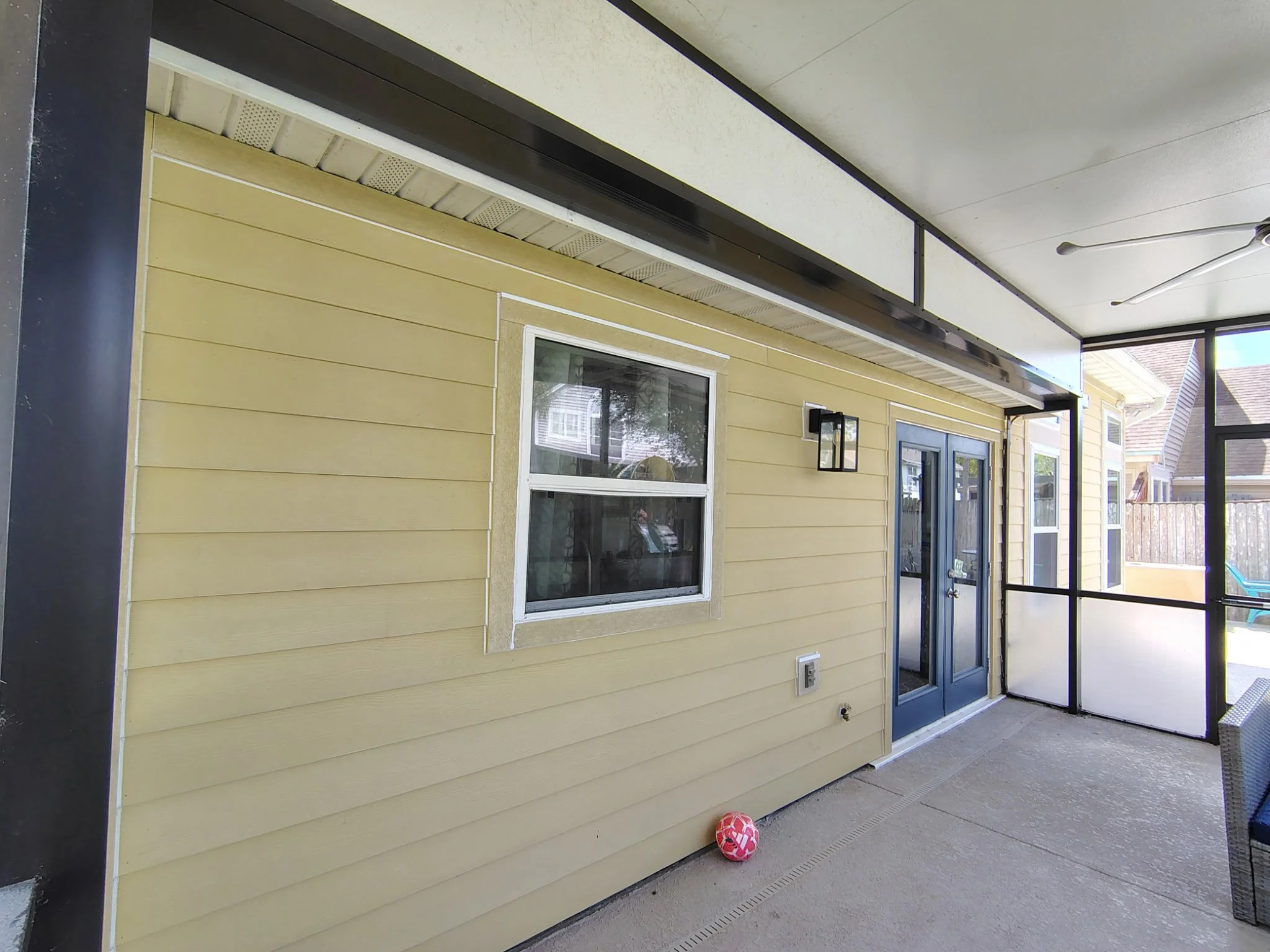 Screened patio exterior before painting in Longwood FL showing siding condition