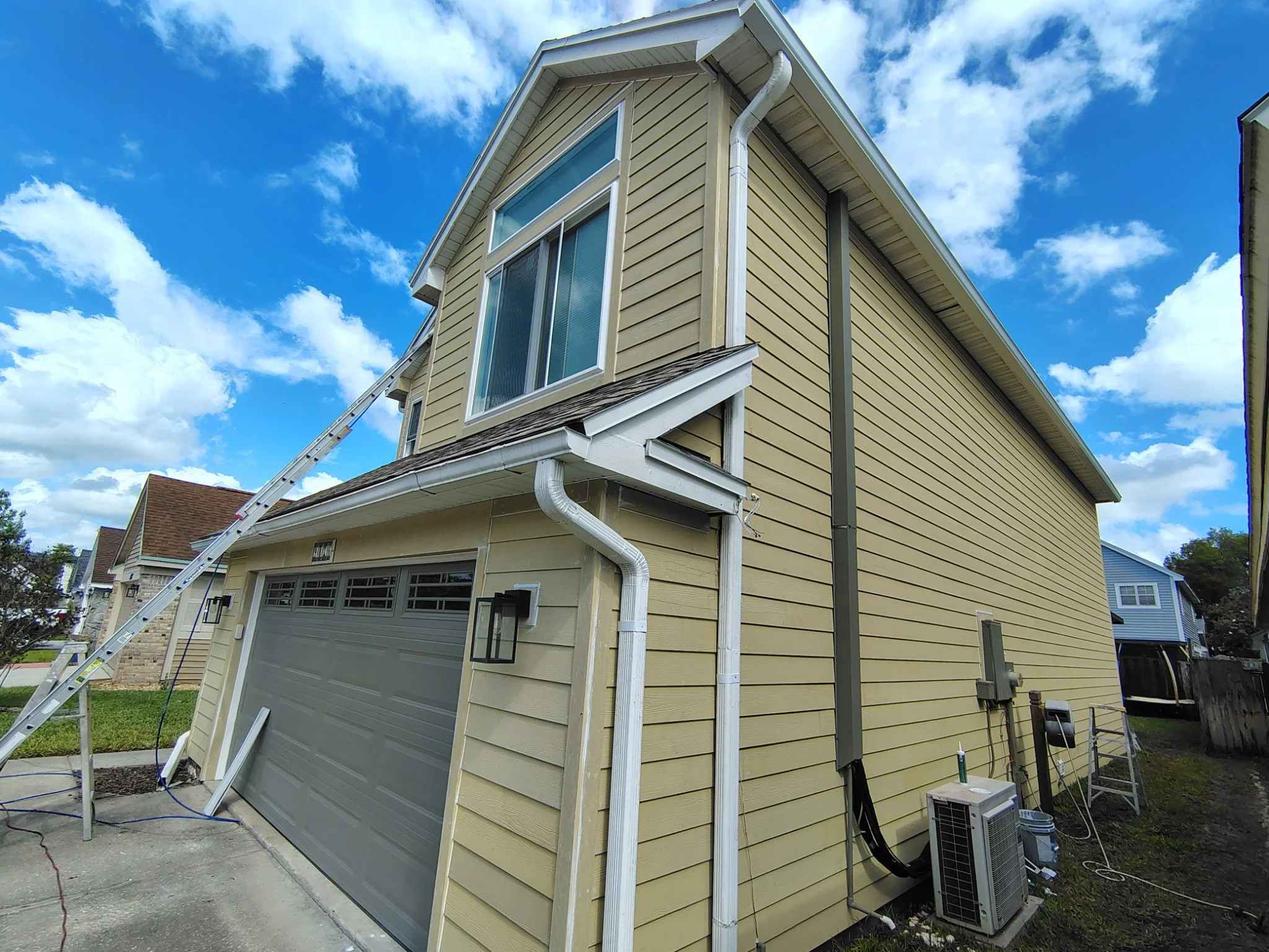 Garage exterior of Longwood FL home before painting with visible wear on siding