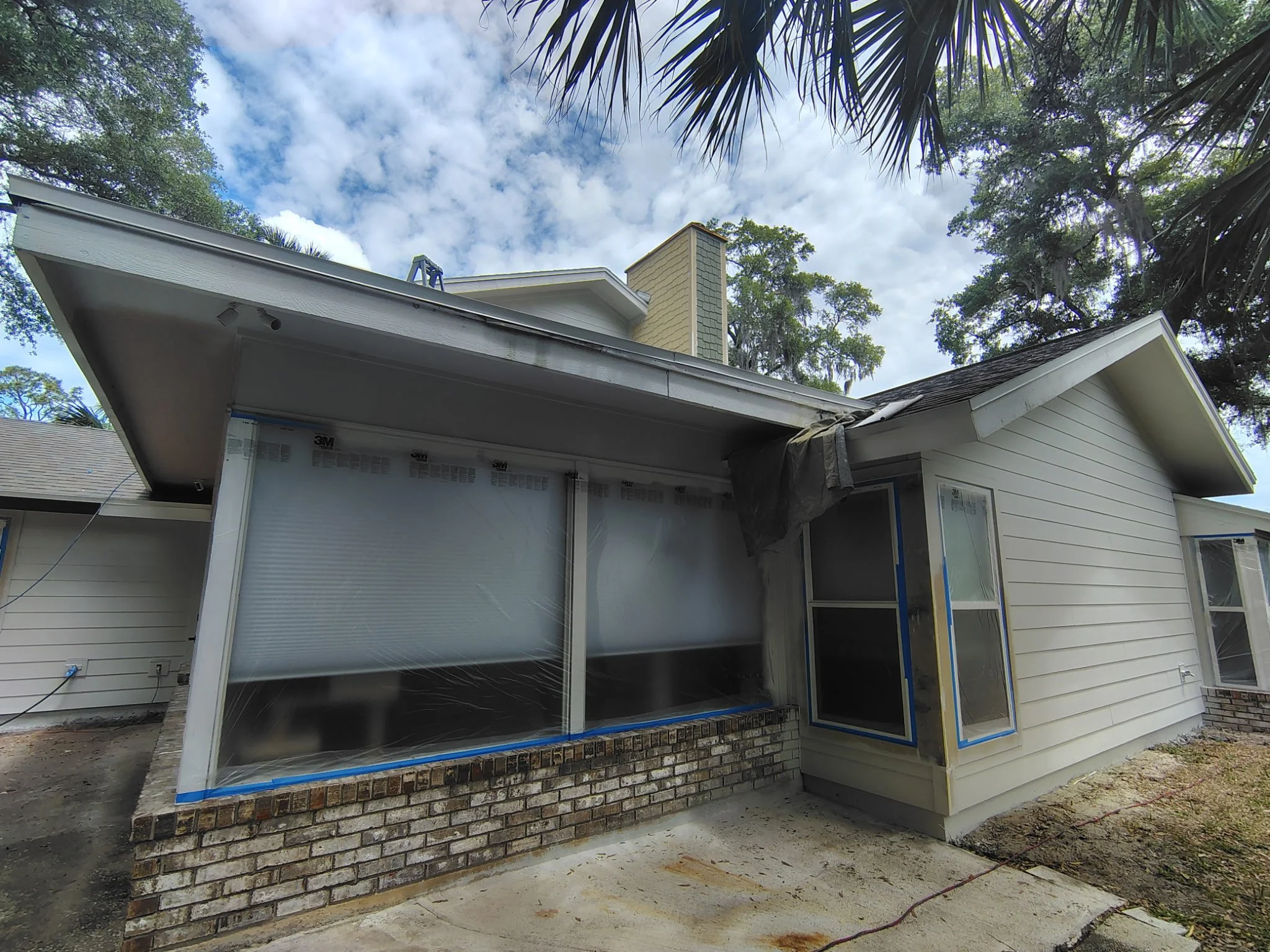 Exterior painting preparation in a covered patio area in Port Orange with surfaces cleaned and protected for final application