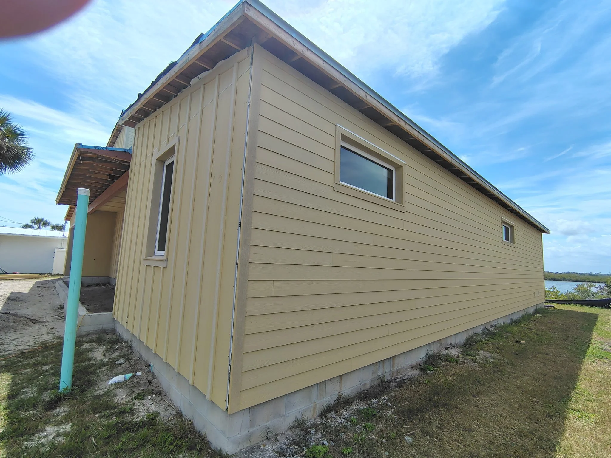 Corner view of South Daytona home before painting showing modern siding and clean architectural lines