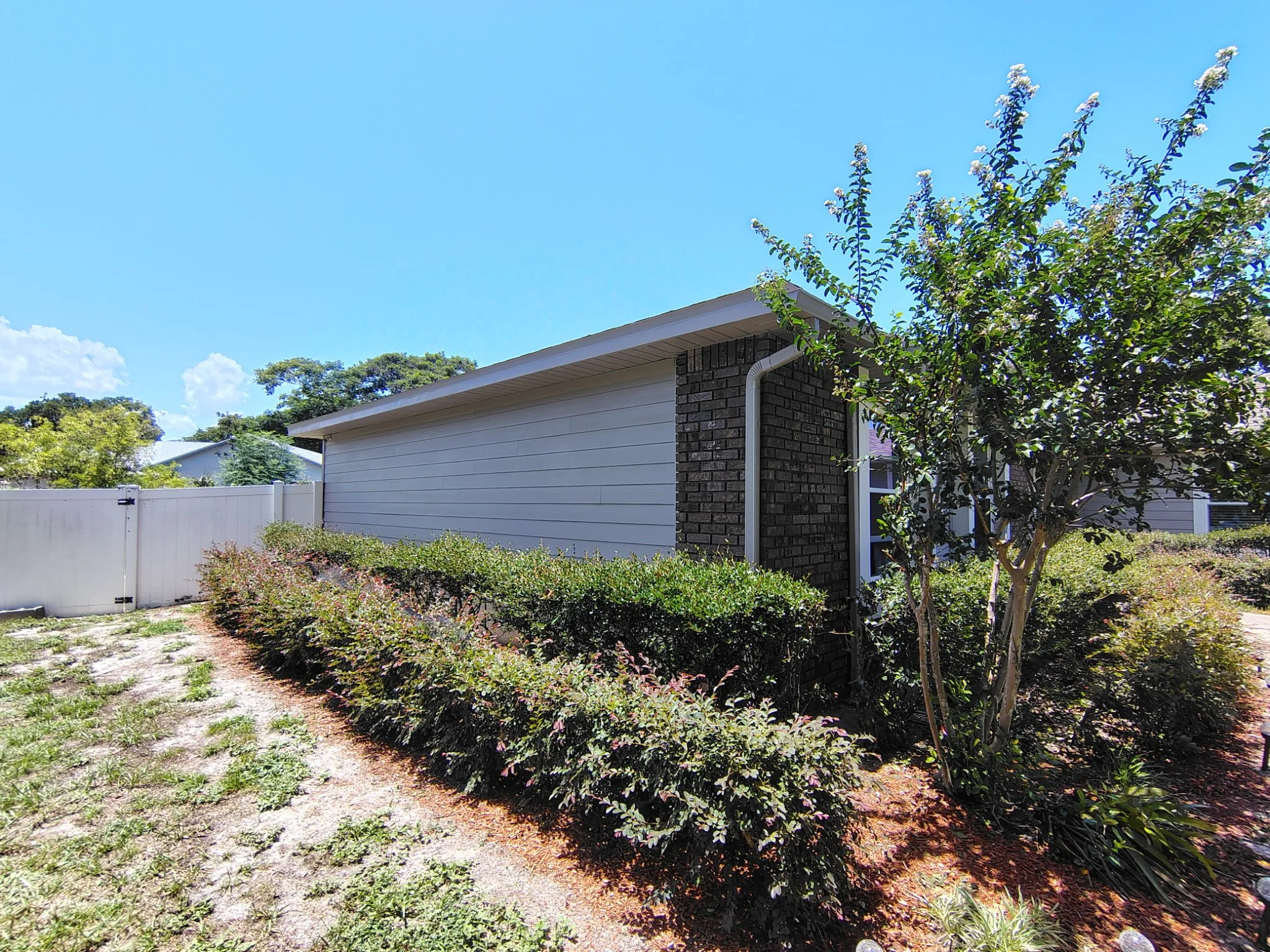 Gray siding and dark brick color combination on a finished Ocoee Florida home