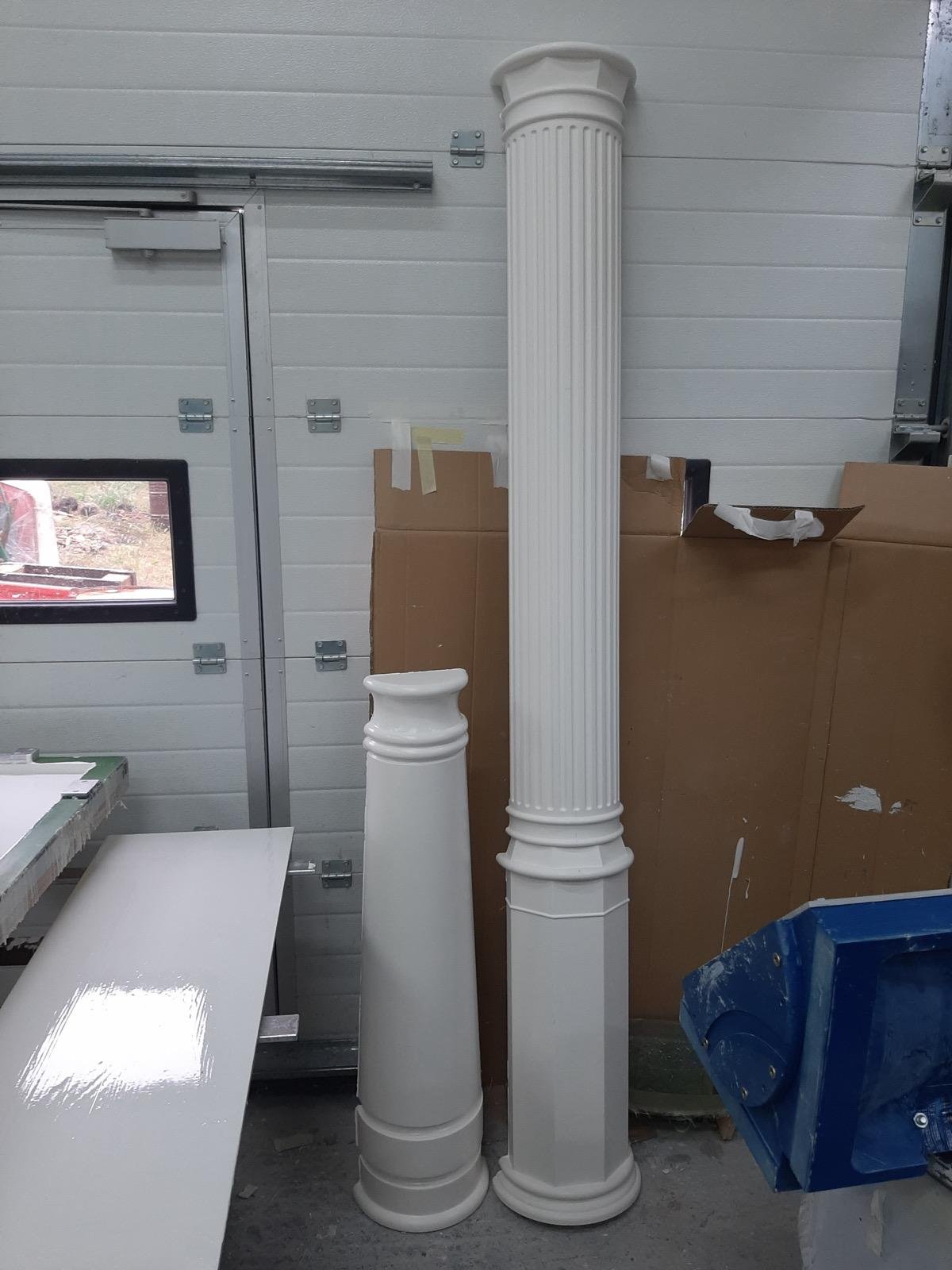 White decorative pillars of different sizes and designs made from fiberglass composites