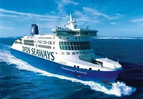 Ferry boat with DDFS SEAWAYS written on the side, sailing on the ocean under a blue sky.