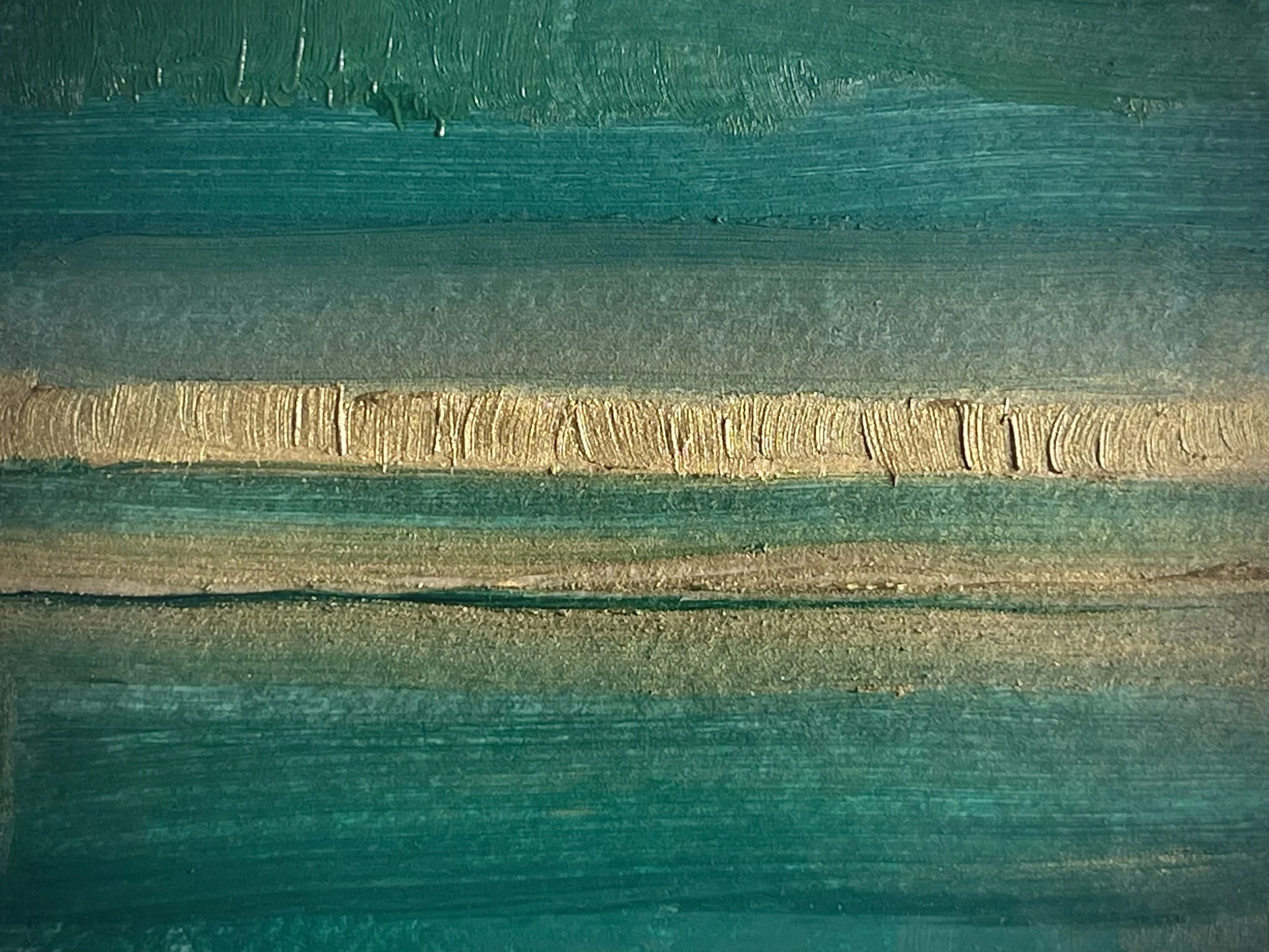 Close-up photo of a painted surface with horizontal layers of teal, gold, and greenish shades, showing textured brush strokes.