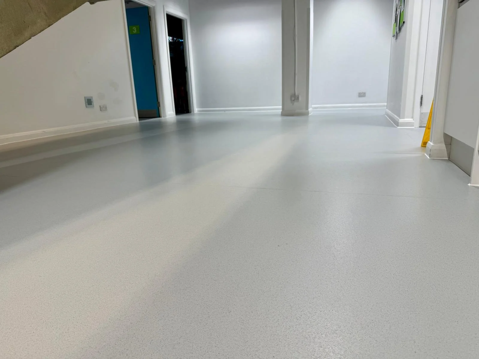 White vinyl corridor flooring deep-cleaned and restored.