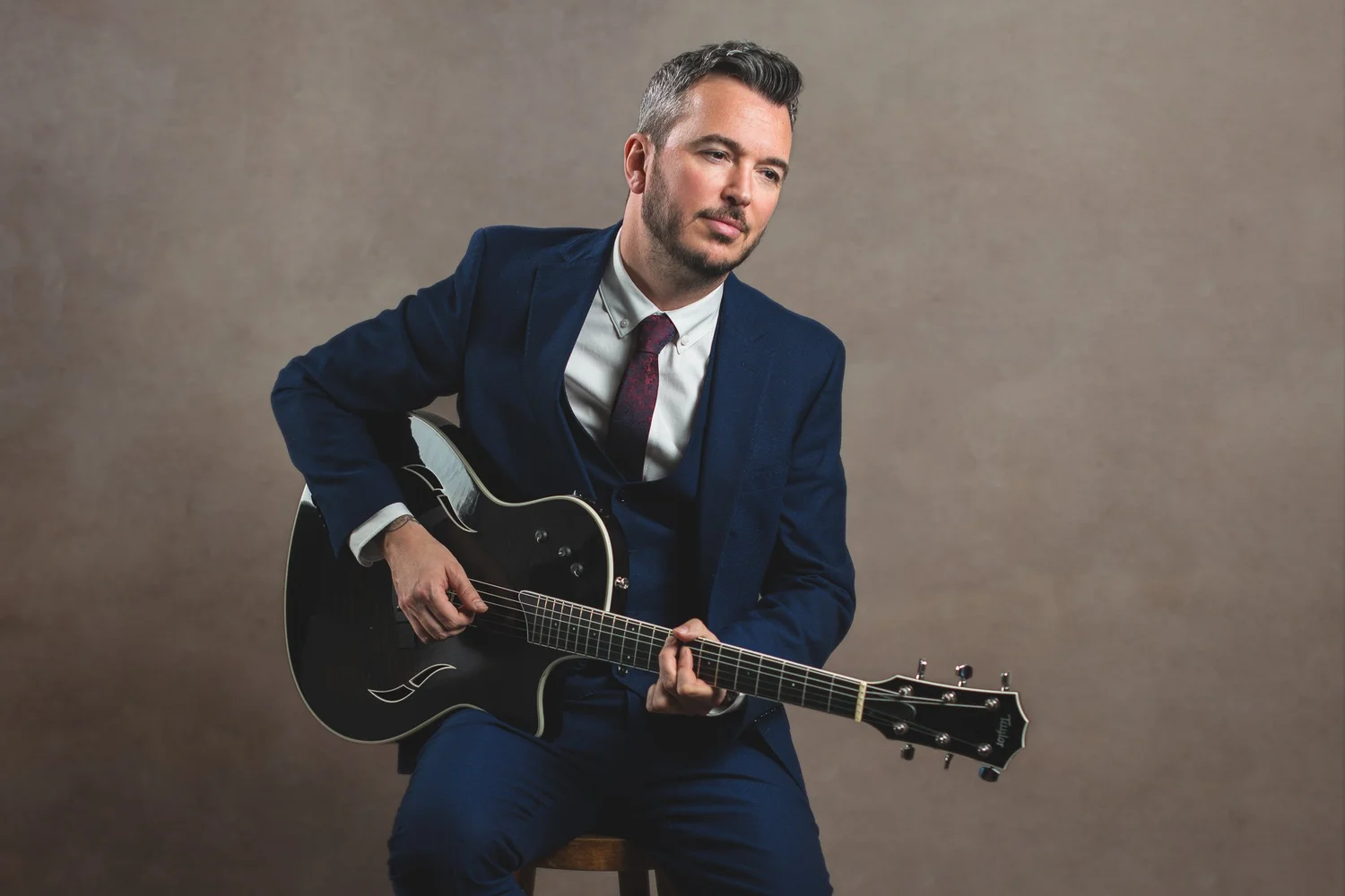 Matt, Leeds wedding singer and guitarist, in a blue suit