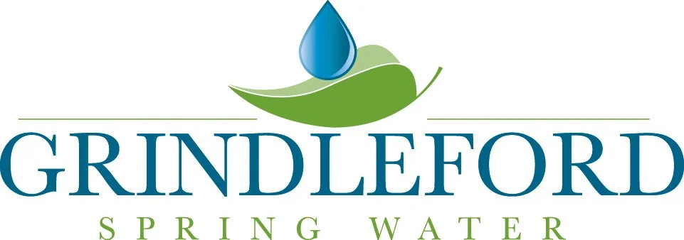 Logo for Grindleford Spring Water featuring a blue water droplet above a green leaf.