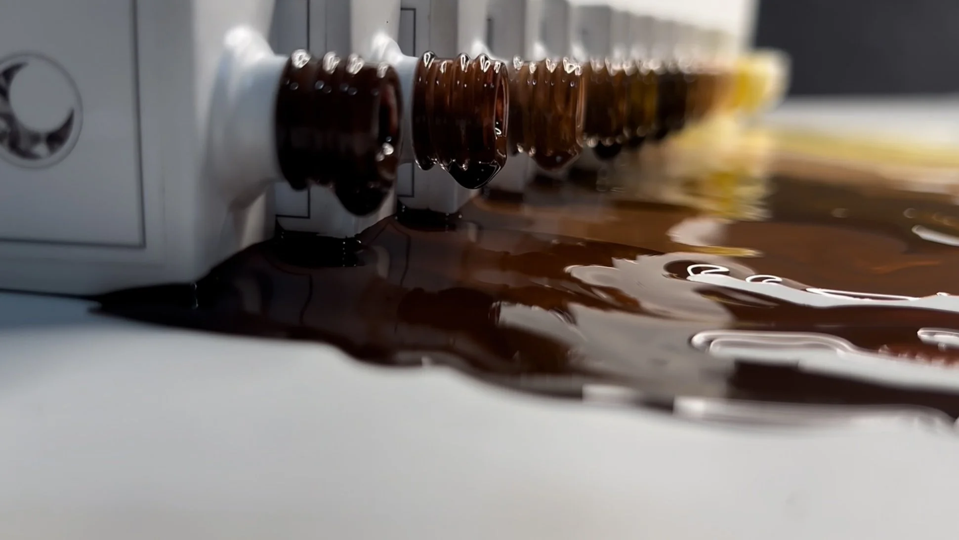 Close-up of crystal crescent gel polishes flowing over its tiers.