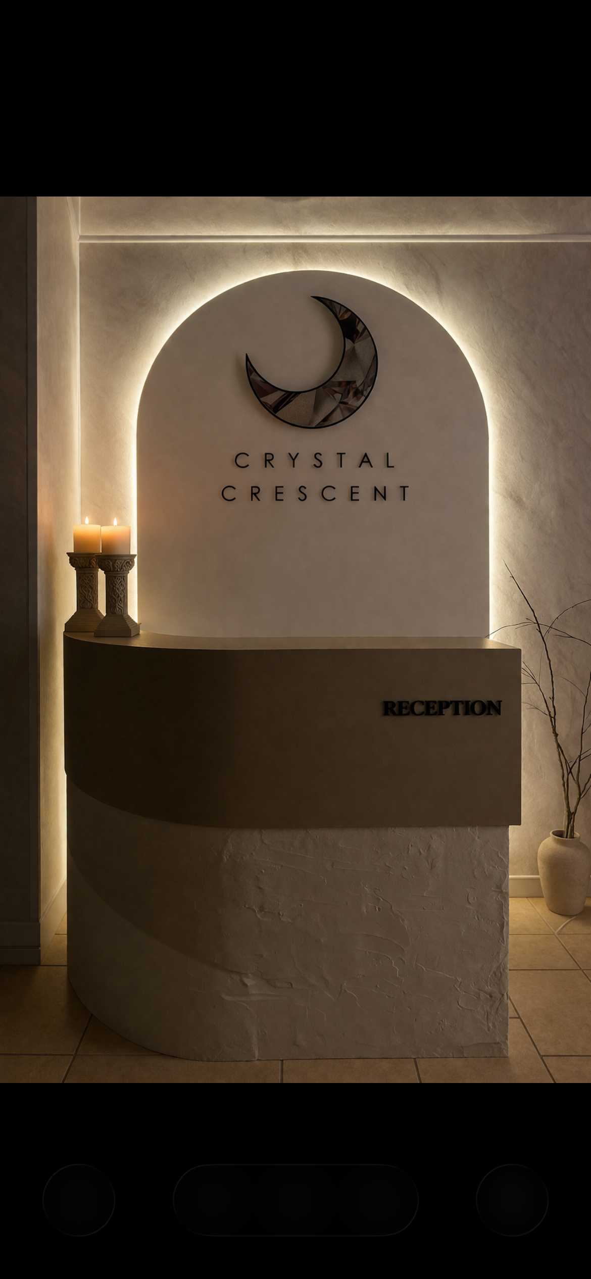 Reception desk at Crystal Crescent with candle holders, a crescent moon decoration, and a plant in a vase.